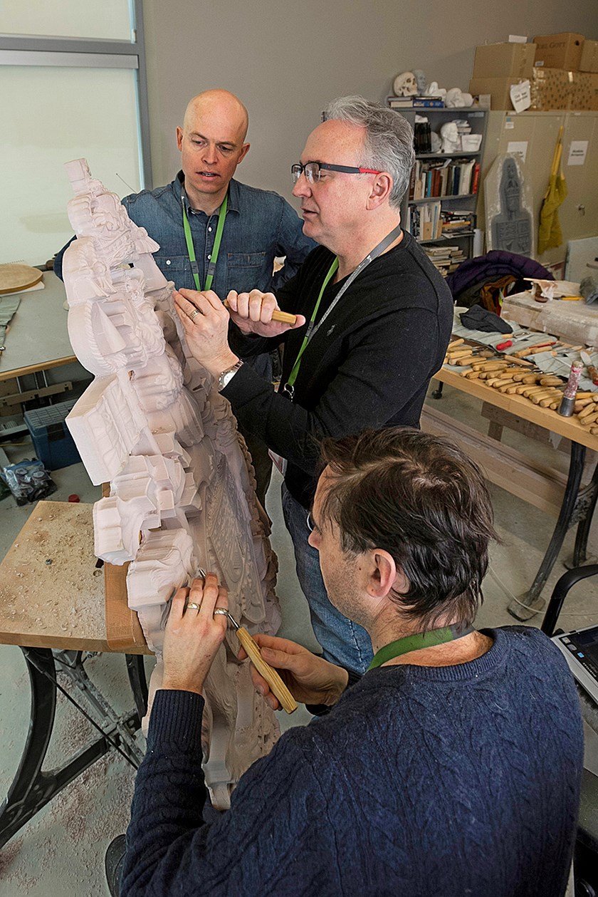 Mr. White and his two assistants, John-Philippe Smith (left) and Nicholas Thompson (right), work on a model for the Arms of Canada cast in bronze and mounted on the north face of Ottawa’s Wellington Building in 2019. (Photo credit: Public Services and Procurement Canada)