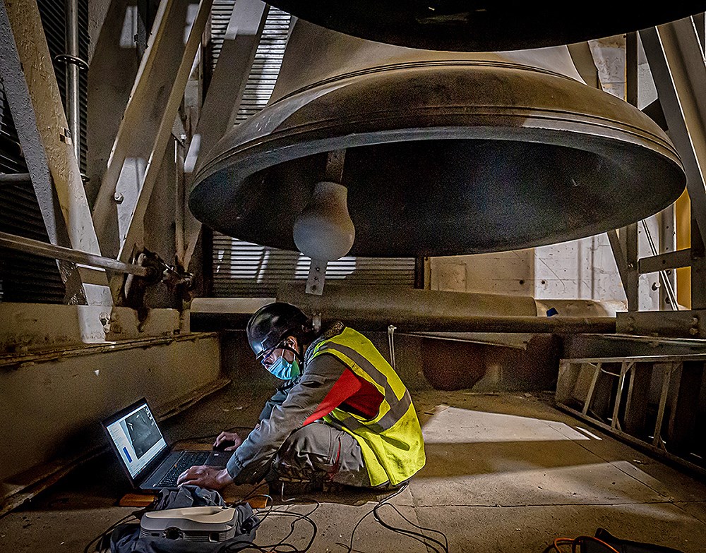 Royal Eijsbouts acoustics expert Miguel Carvalho assesses the state of repair of one of the carillon’s big bells while making a 3-D scan of its interior. (Photo credit: Public Services and Procurement Canada)