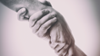 Two hands holding each other. 
