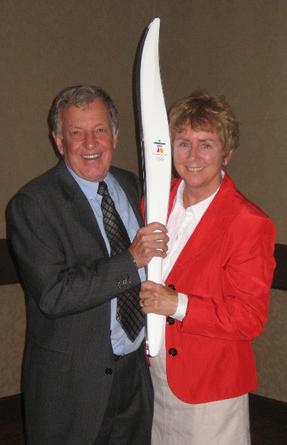 Senator Greene Raine poses with spouse Al Raine and the Olympic torch during the 2010 winter Olympics in Vancouver.