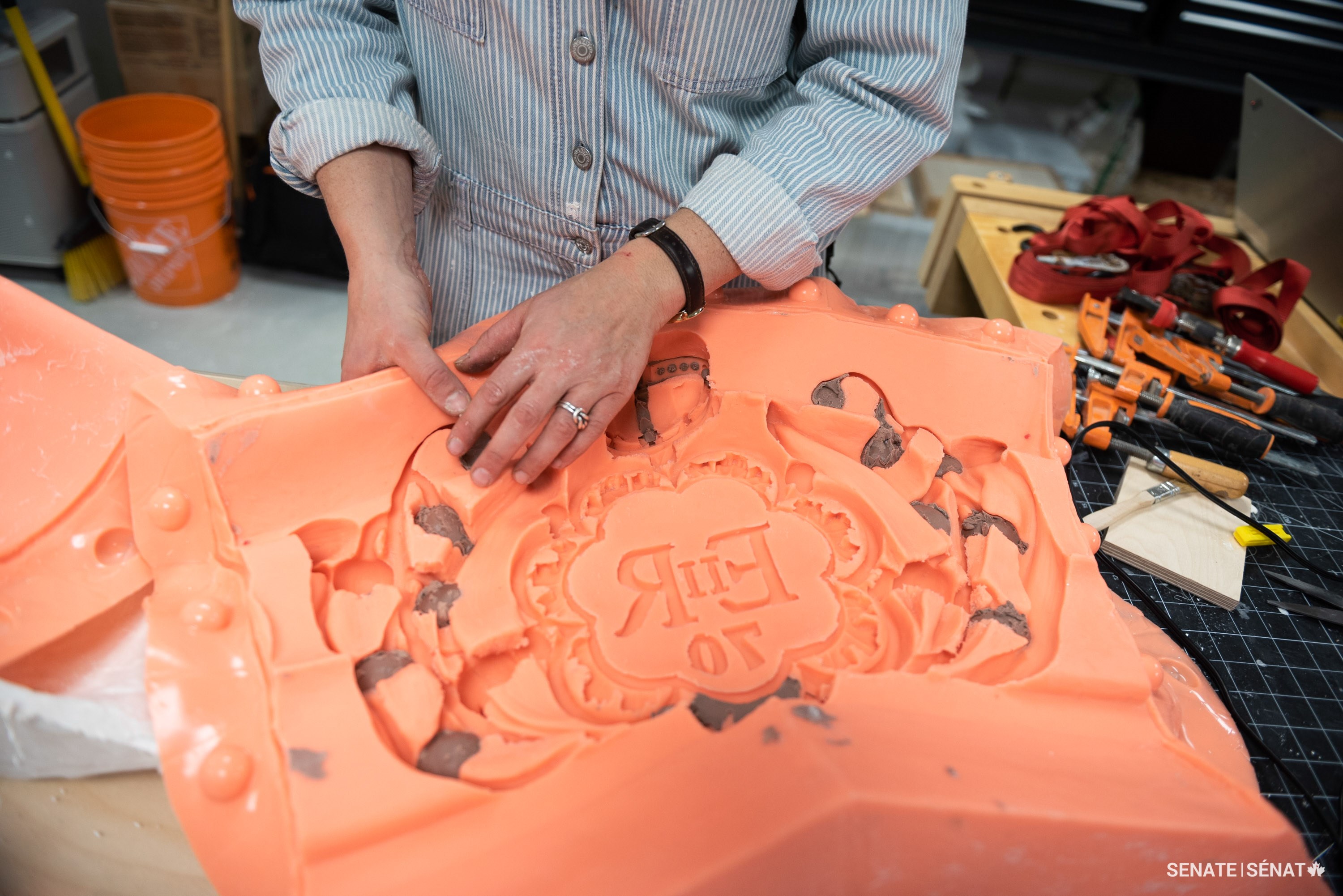 The silicone cures to form a pliable shell. This mould is used to cast the plaster maquette.
