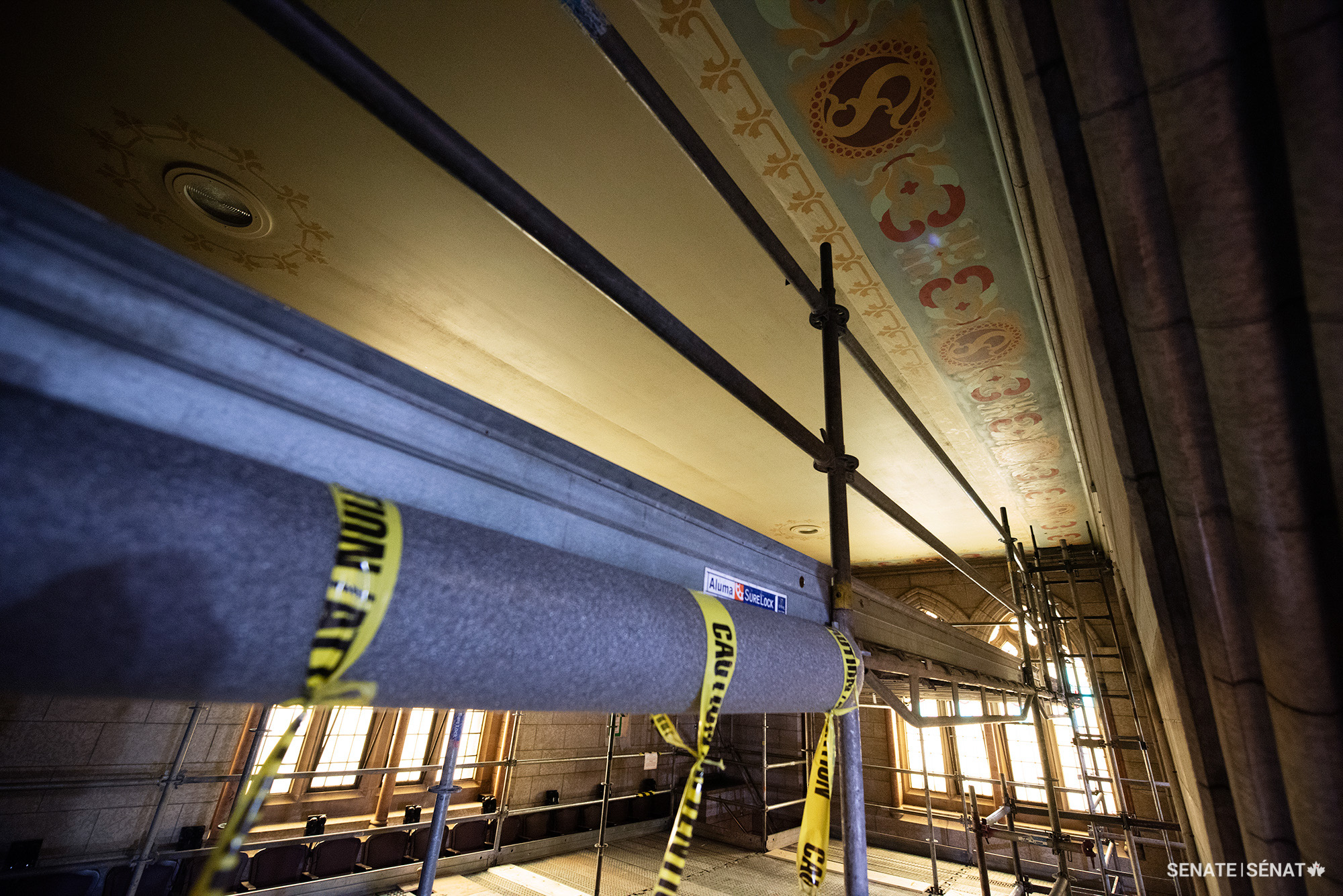 The painted linen ceilings in the Senate’s galleries feature an understated colour palette, provincial symbols and lattice stencilling that conceals the seams between the bolts of linen.