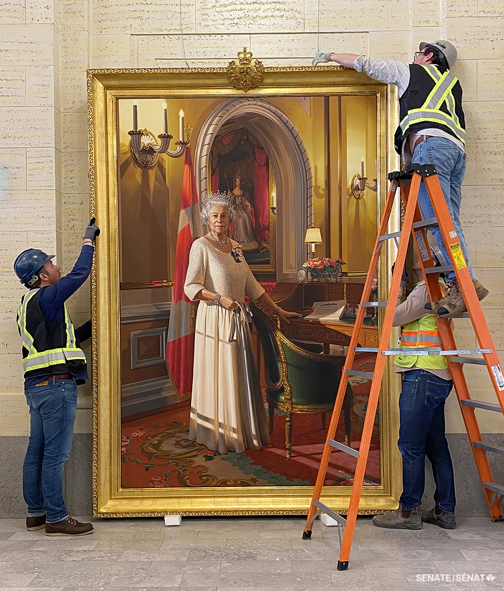 Art conservators from Ottawa’s Legris Conservation prepare to mount the Diamond Jubilee portrait in the Senate of Canada Building’s main entrance in January 2025.