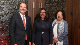 Three senators pose outside the Red Chamber.