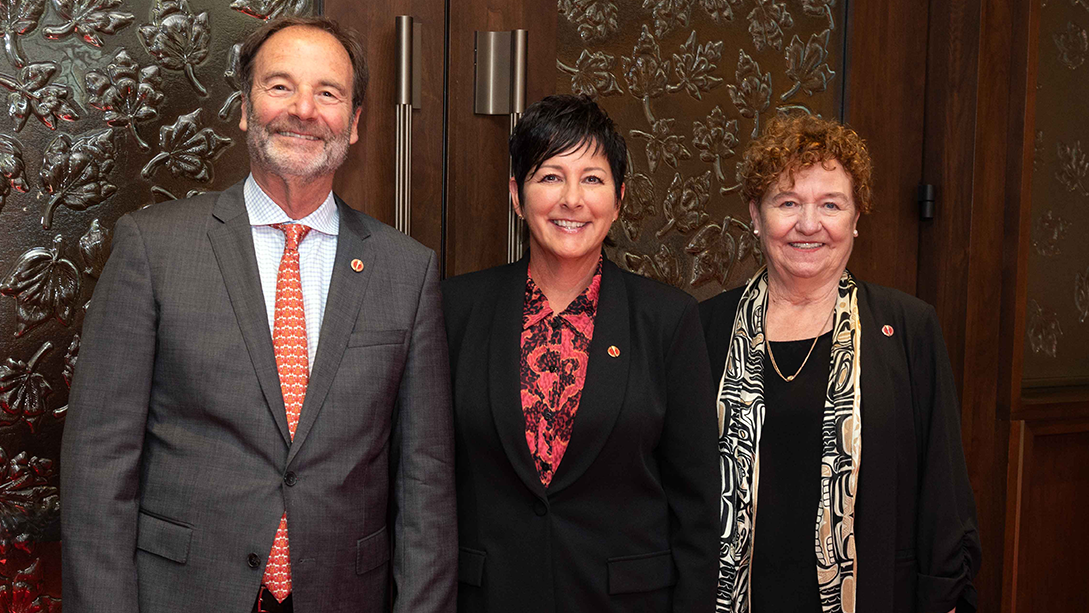 Three senators pose outside the Red Chamber.