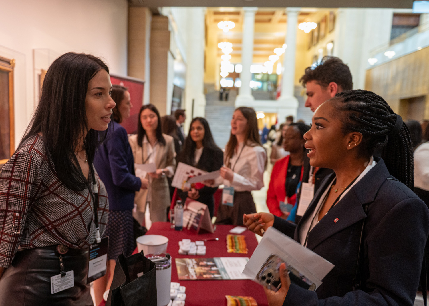 People discuss together around a booth.