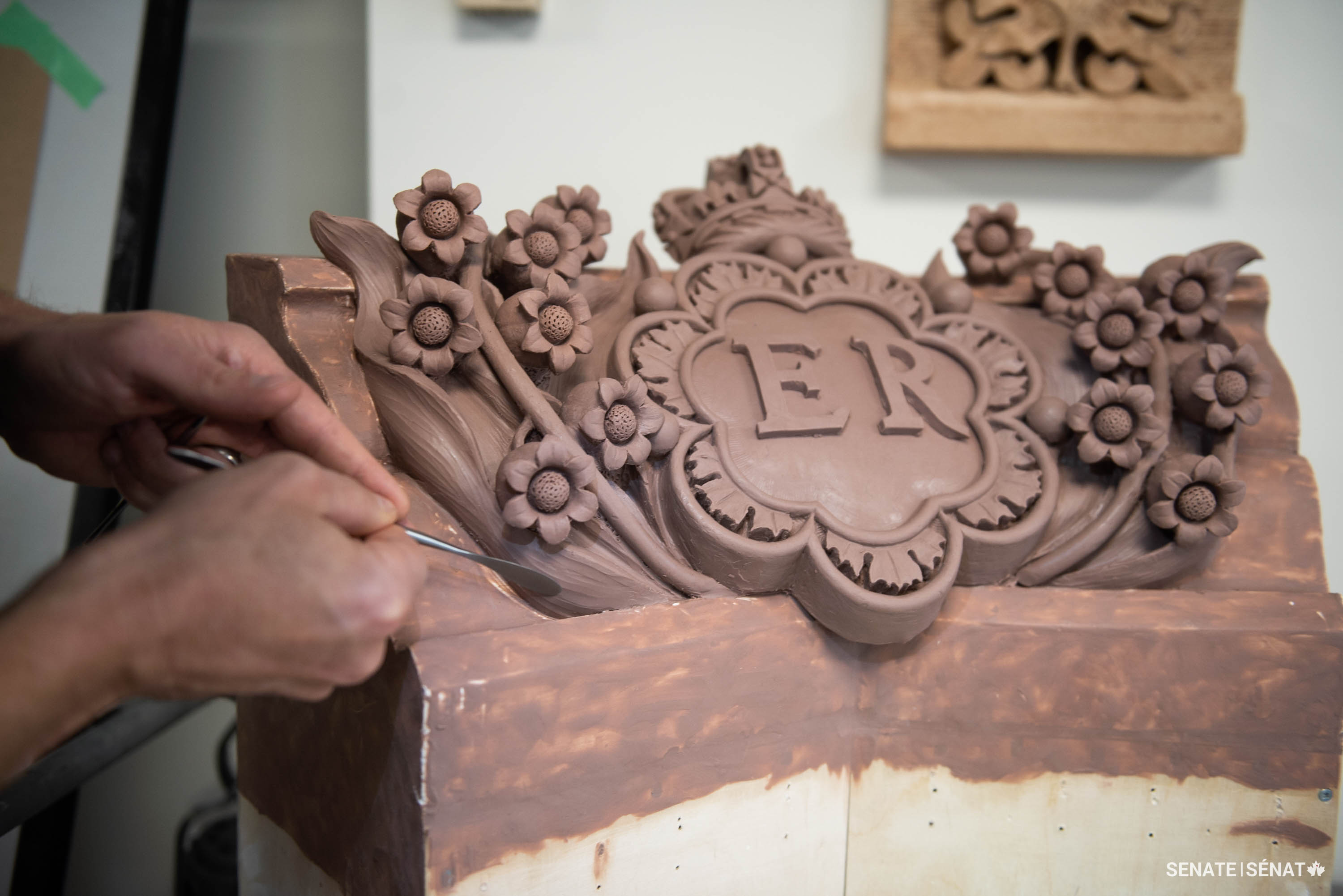 Mr. Smith adds subtle textures to the nearly complete clay model.