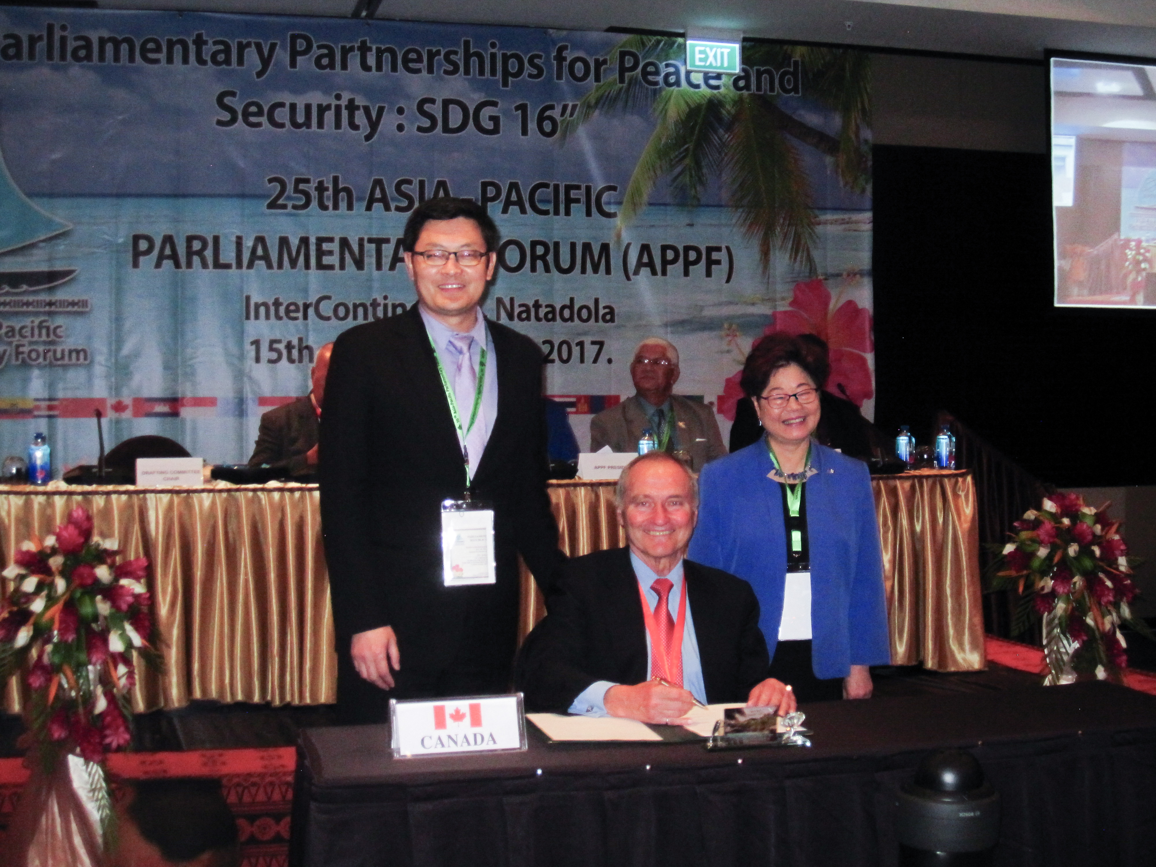 The Canadian delegation signs the Joint Communiqué at the closing plenary of APPF 25. From left to right: MP Geng Tan, Senator Joseph A. Day, MP Alice Wong.