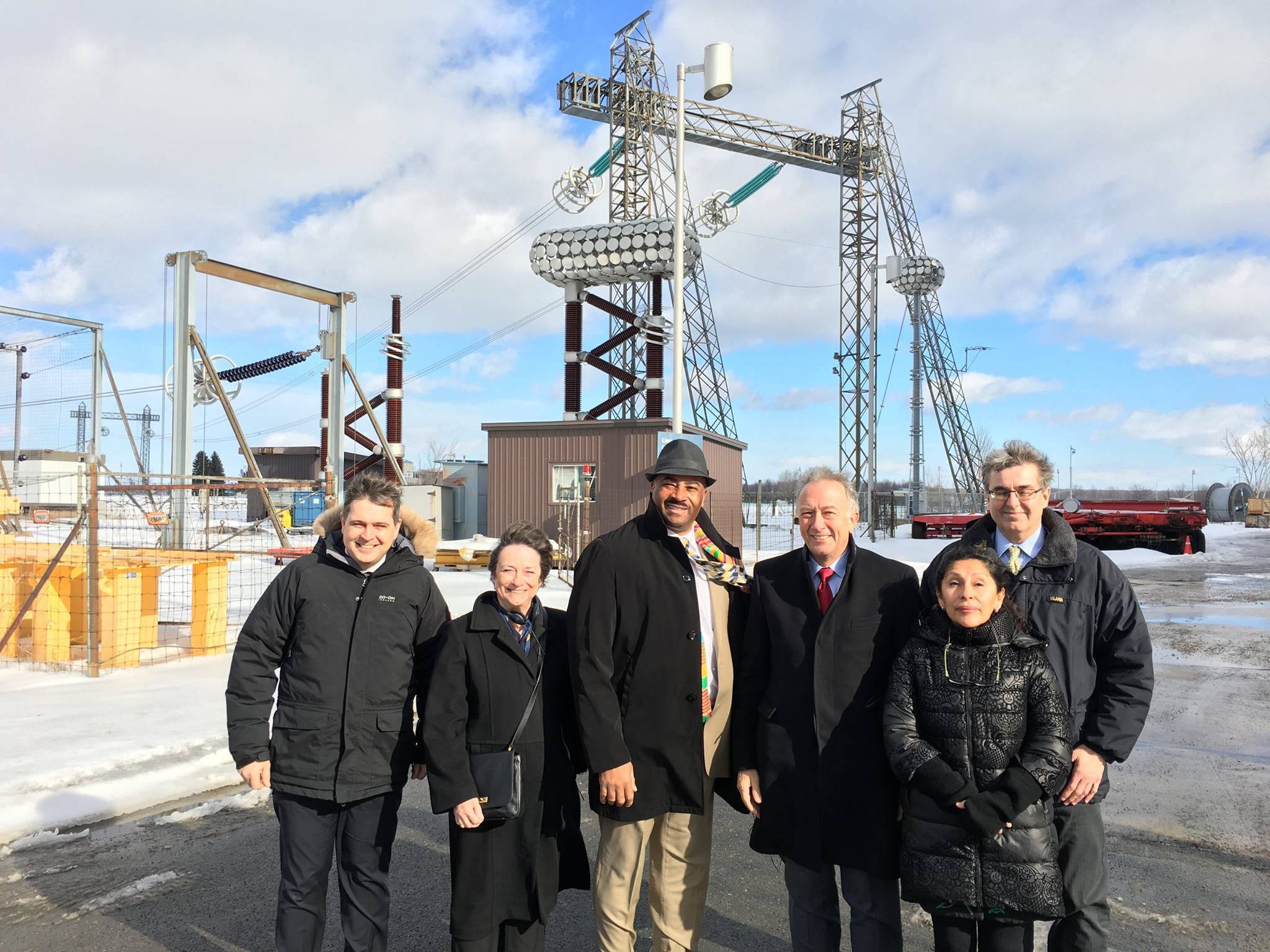 Jérôme Gosset, Director (far left) and Jean-Pierre Tardif, Communications and Marketing Advisor (far right) from Hydro Quebec’s Research Institute pose with committee members Senators Griffin, Meredith, Massicotte and Galvez in front of some of the facilities high-tech testing equipment on February 8th, 2017 in Varennes.