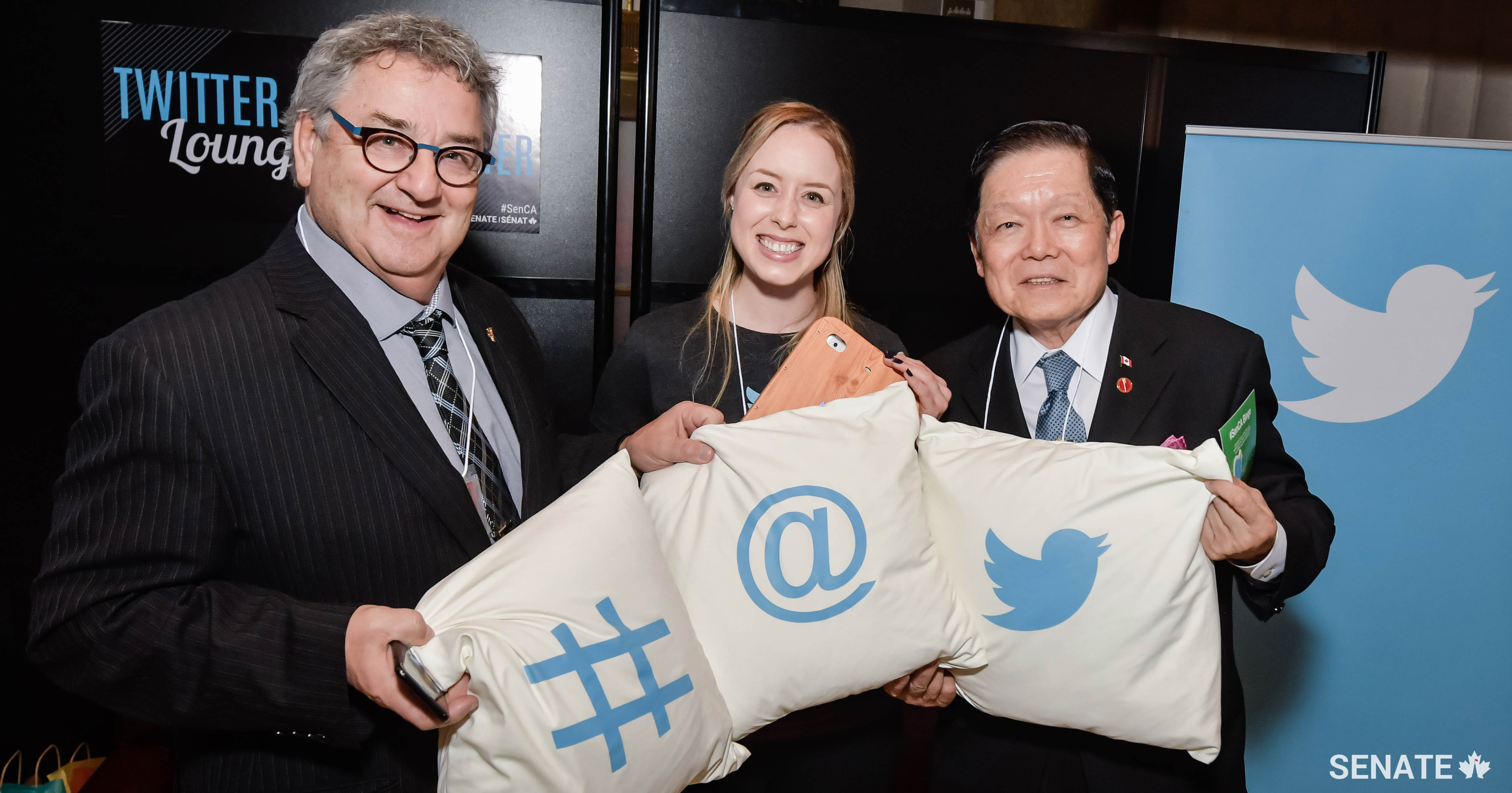 Geneviève Guindon joins Senators Éric Forest (left) and Victor Oh in a shout out to event co-host Twitter Canada