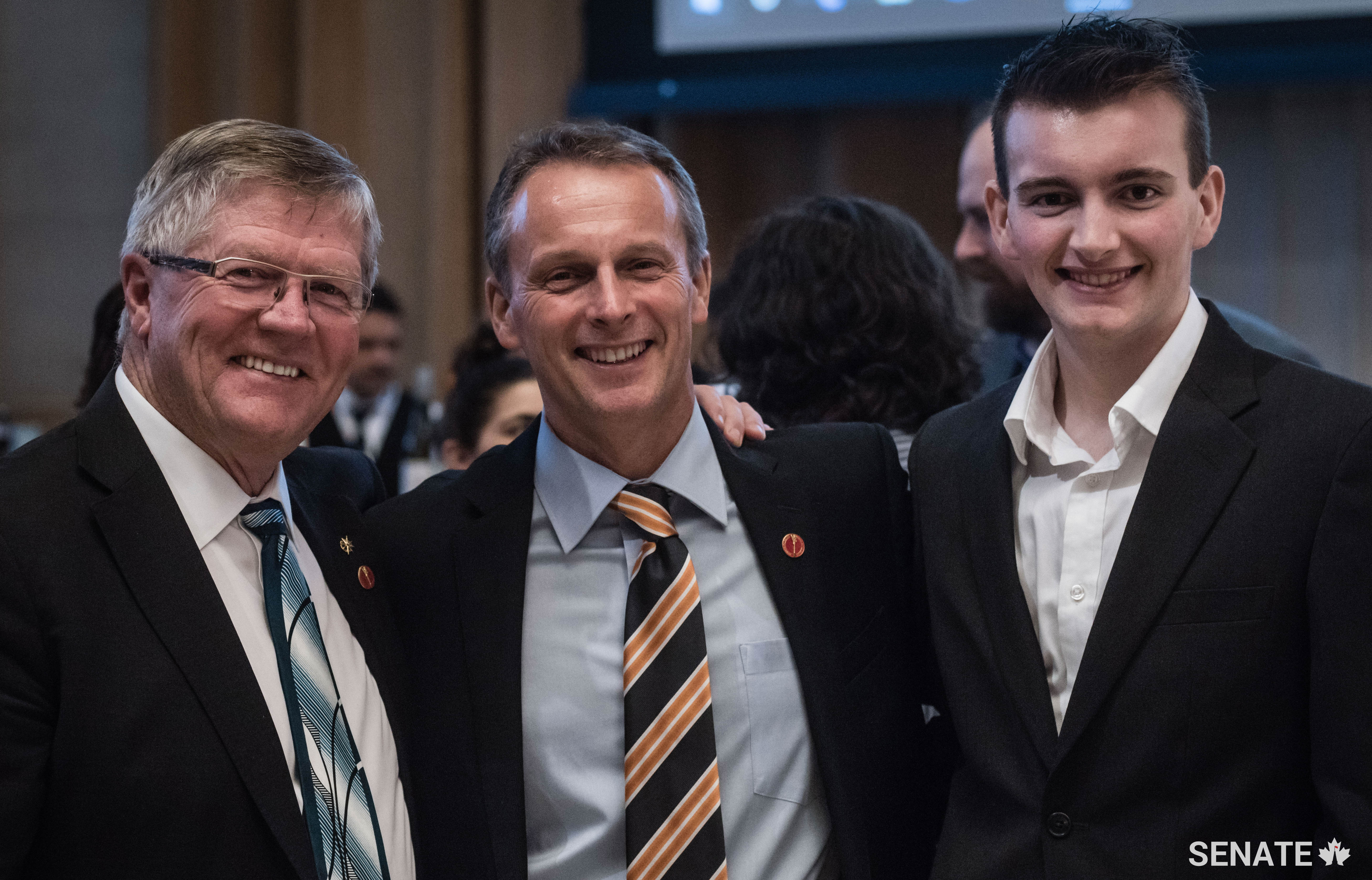 Senator Don Plett (left), Senator David Wells and his son, Luke, enjoy the event.