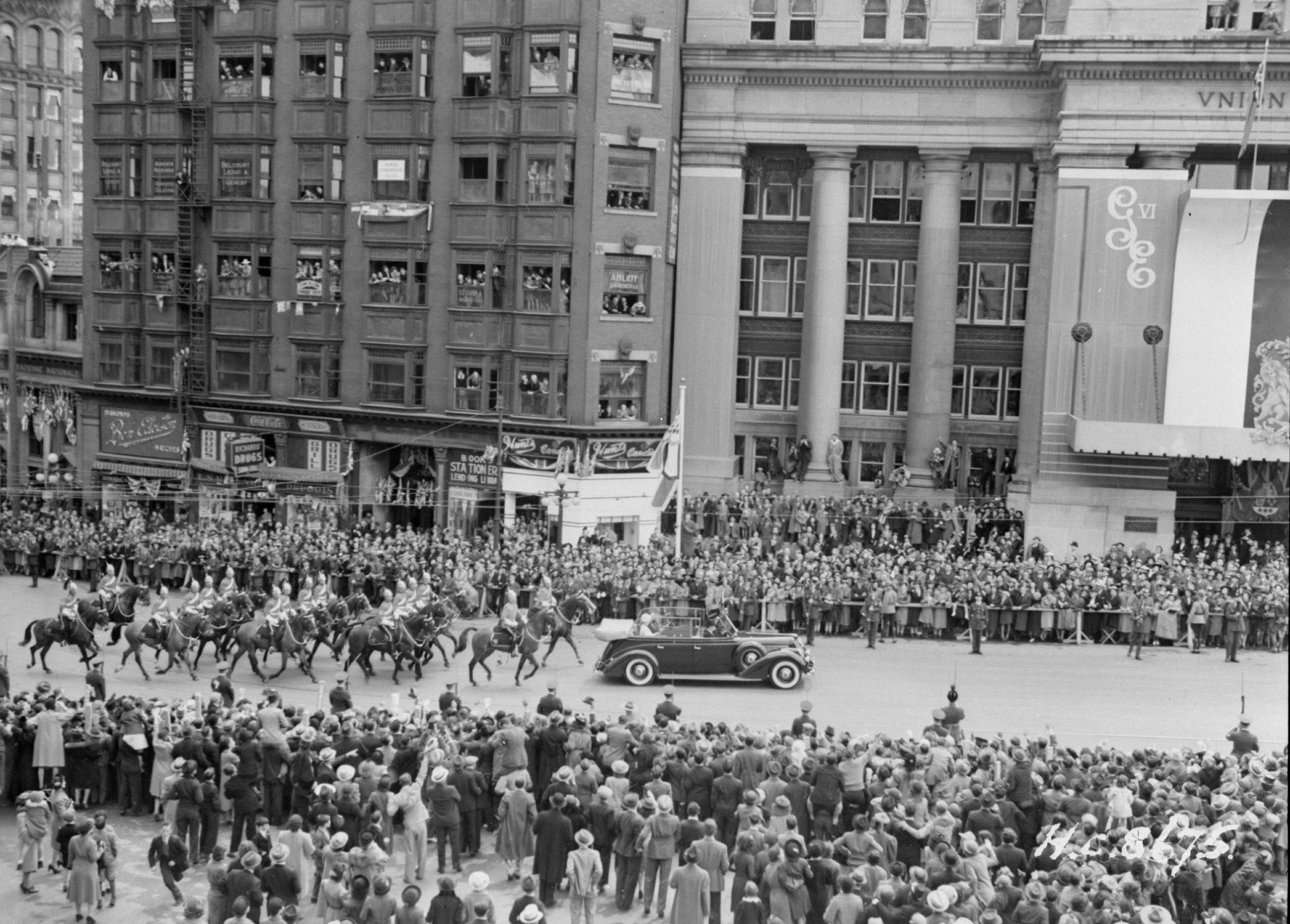 King George VI and his consort, Queen Elizabeth, later known as the Queen Mother, pass in front of Union Station on May 20, 1939, during a four-week cross-Canada royal tour.