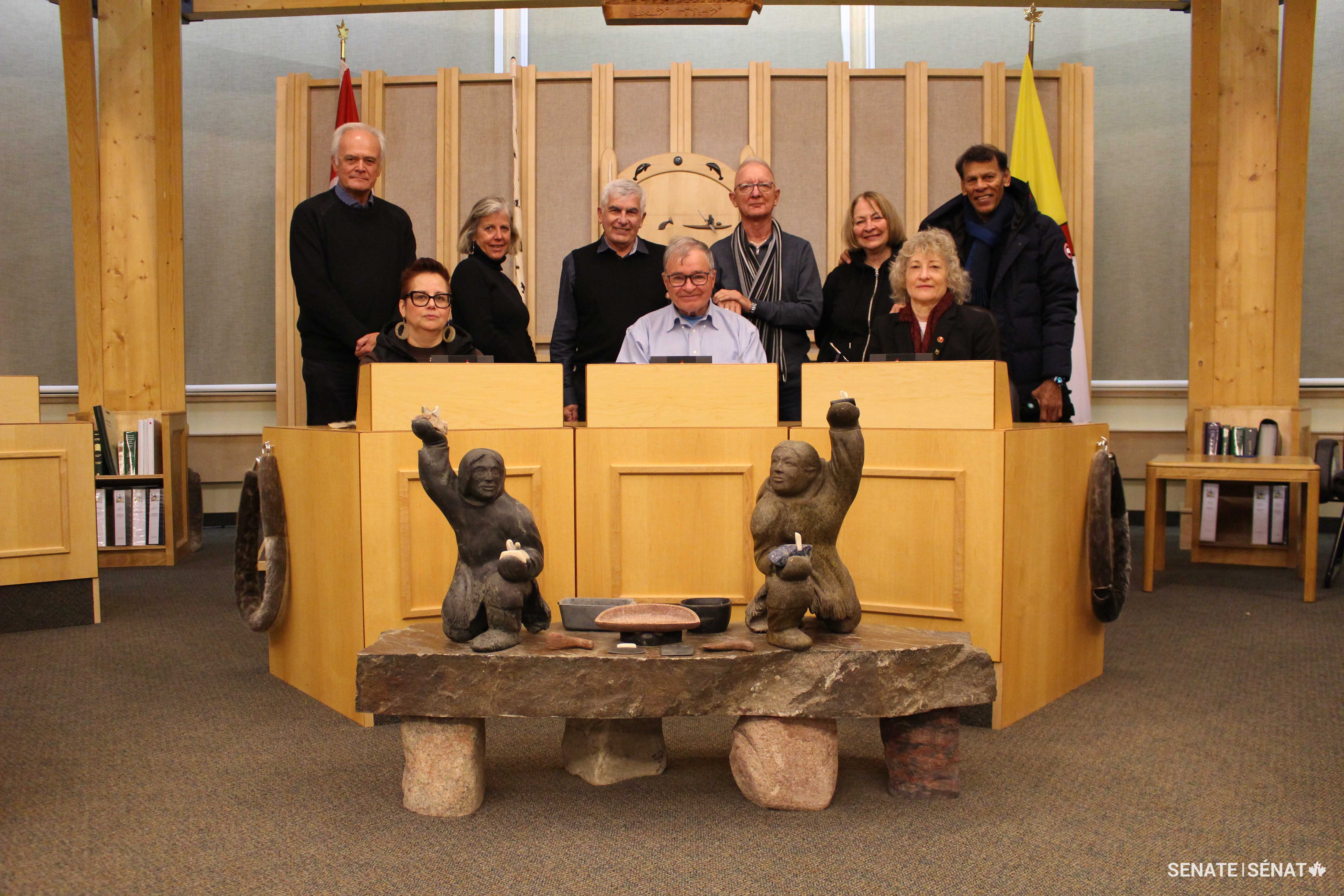 The fact-finding mission united all three northern senators in the Nunavut legislature: in the front row, from left, are senators Margaret Dawn Anderson (Northwest Territories), Dennis Patterson (Nunavut) and Pat Duncan (Yukon). In the back row, from left, are senators Peter Boehm, Marty Deacon, Clément Gignac, Pierre-Hugues Boisvenu, Donna Dasko and Hassan Yussuff.