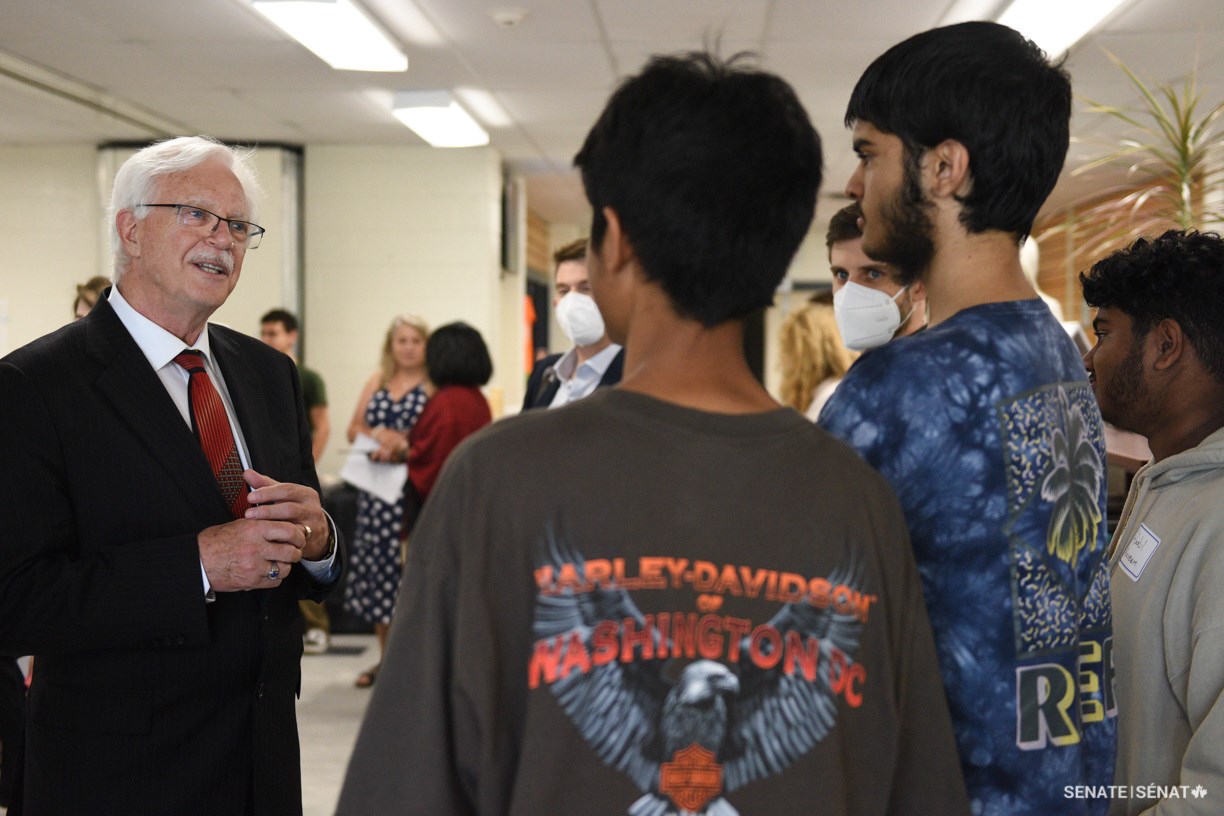 Senator David M. Arnot speaks with students during a visit to Clarkson Secondary School in Mississauga.