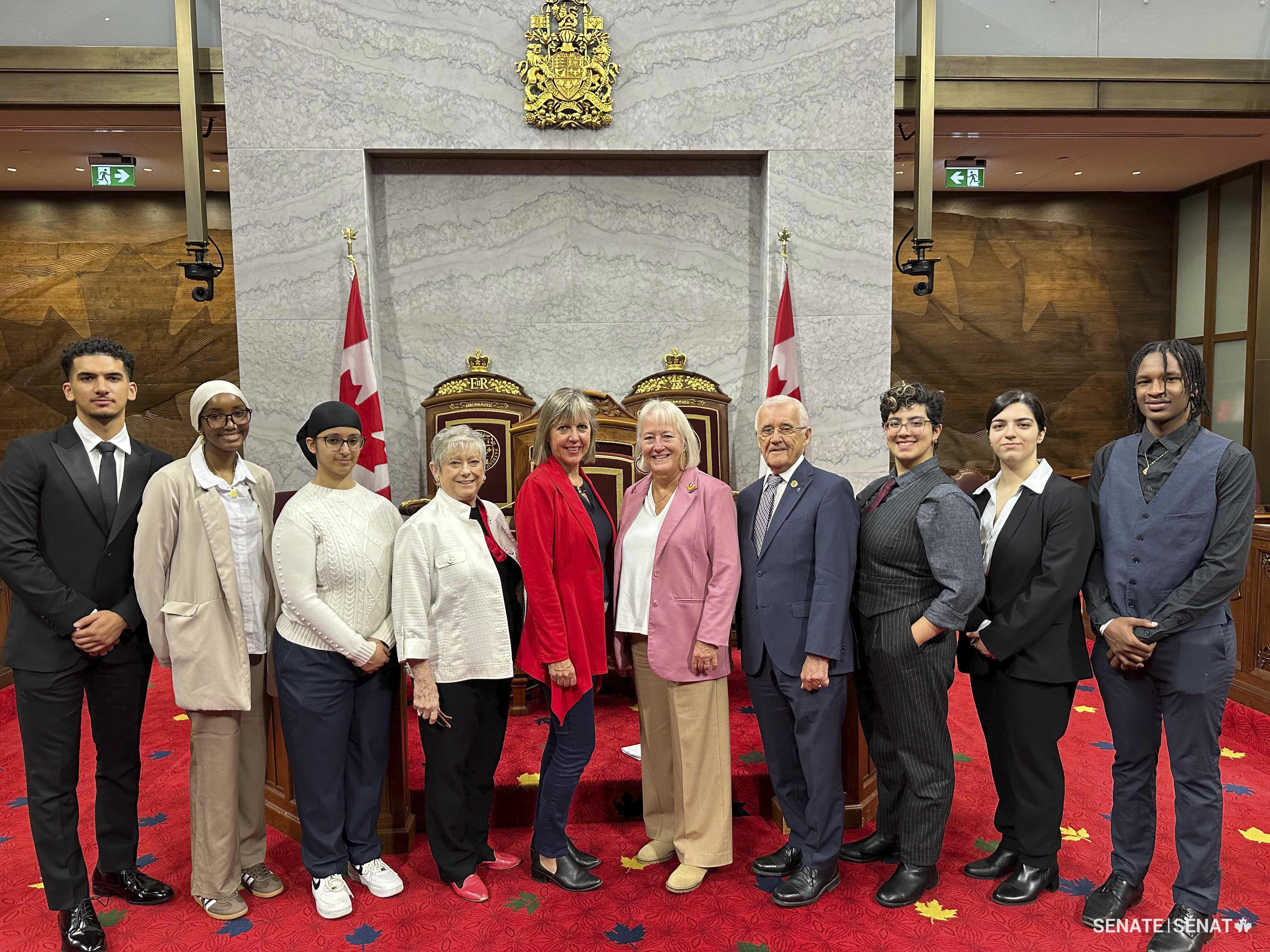 Thursday, October 24, 2024 – Senators Marty Deacon, fifth from left, Joan Kingston, sixth from left, with members of the Educational Foundation of the Ontario Association of Former Parliamentarians in the Red Chamber; organized by SENgage; Senate of Canada Building, Ottawa, Ontario.