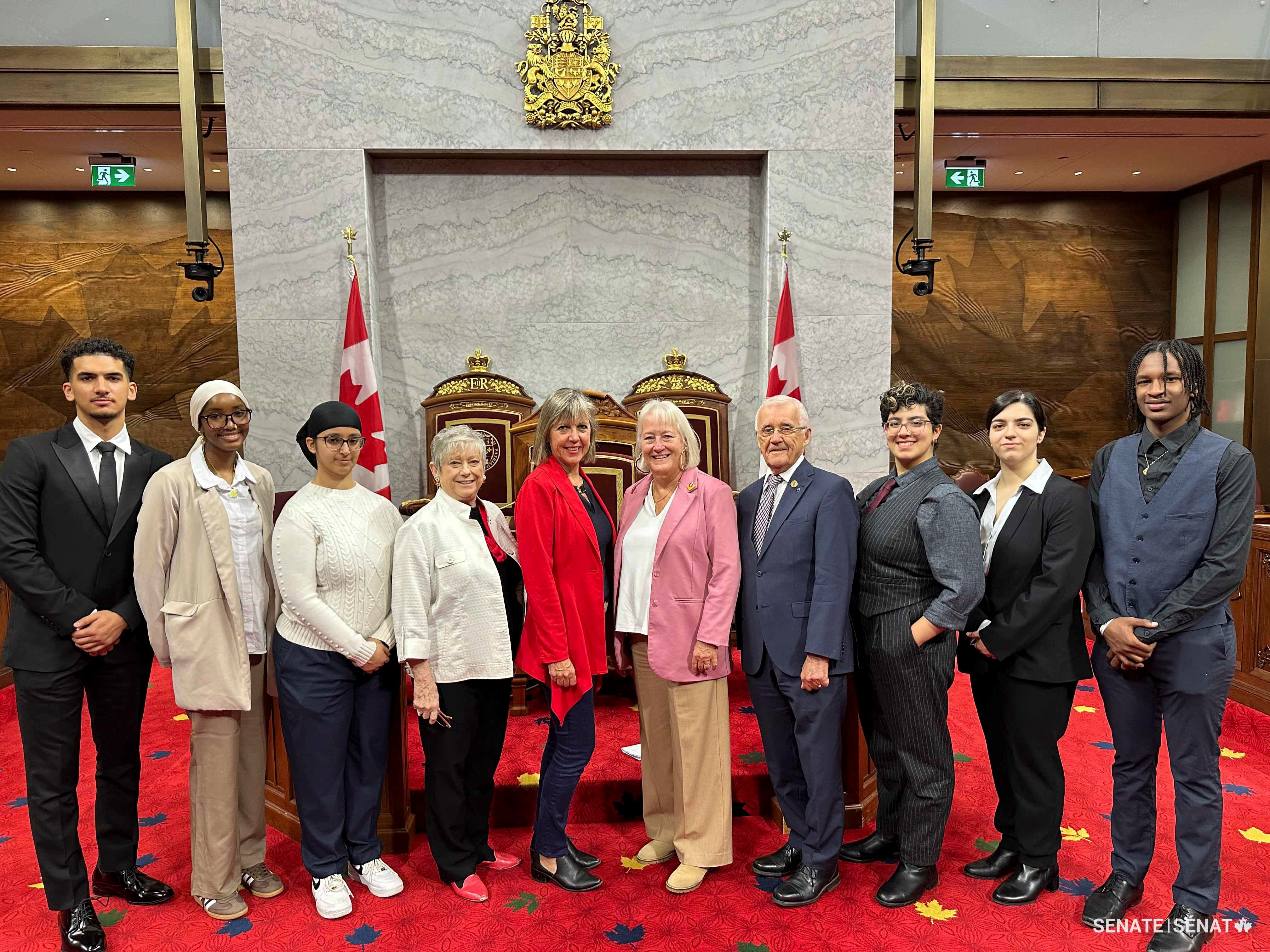 Thursday, October 24, 2024 – Senators Marty Deacon, fifth from left, Joan Kingston, sixth from left, with members of the Educational Foundation of the Ontario Association of Former Parliamentarians in the Red Chamber; organized by SENgage; Senate of Canada Building, Ottawa, Ontario.