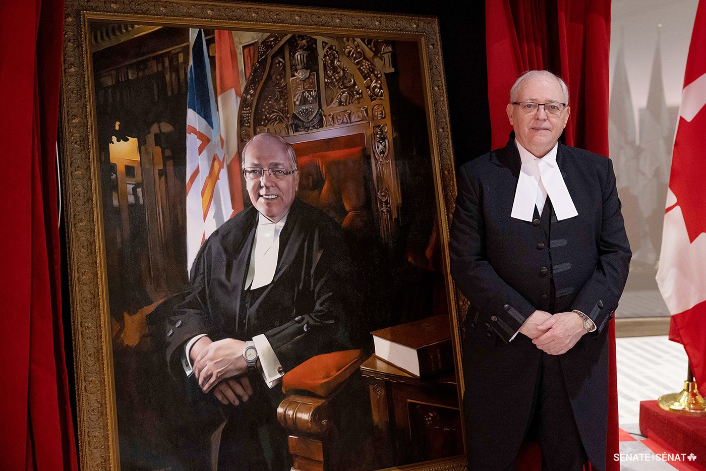 Speaker Furey stands next to his official portrait after it was unveiled in the Senate of Canada Building on Thursday, May 11, 2023.