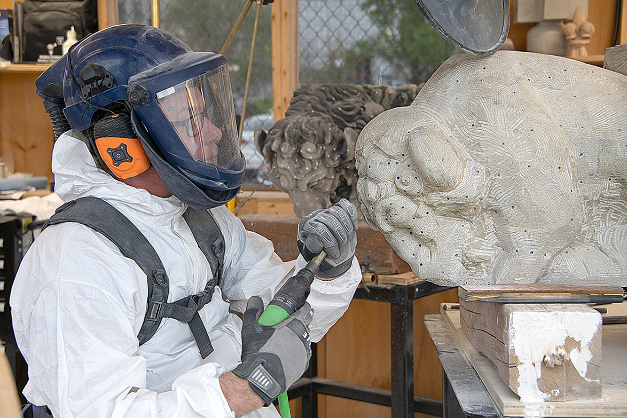 Sandstone contains silica that, when inhaled, can lead to respiratory diseases such as pulmonary fibrosis. Mr. Barber wears protective gear that includes Tyvek coveralls and an air-powered respirator as he works with a pneumatic chisel.
