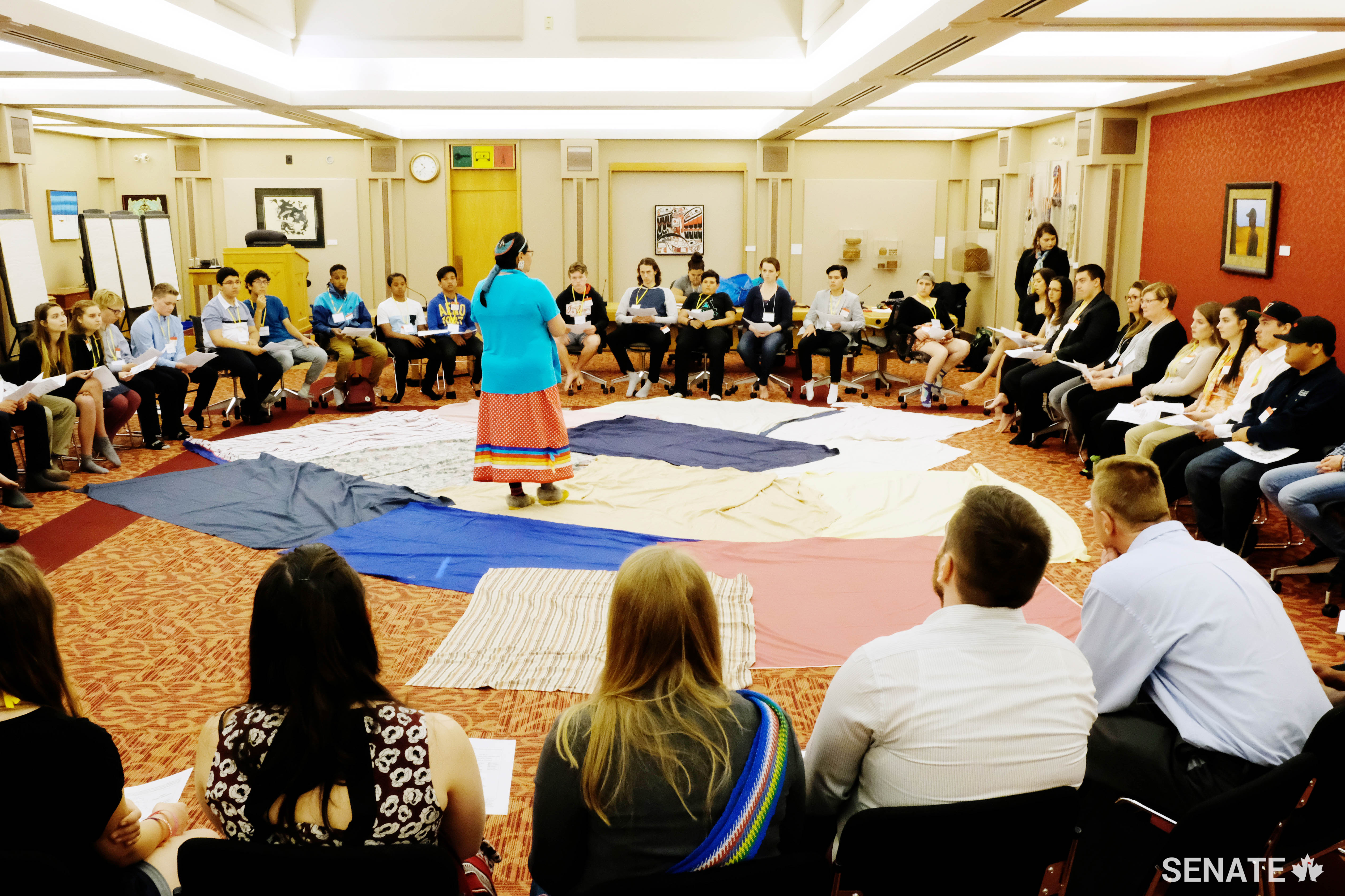 Youth forum participants start the day off with a KAIROS blanket exercise, simulating the loss of land, isolation and trauma experienced by Canada’s Indigenous peoples over the course of colonization.