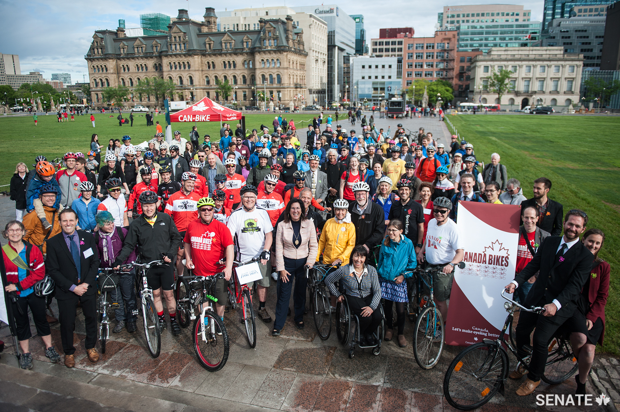 Bike Day on the Hill took place on Thursday, June 1, 2017, starting at the steps of Parliament. Participating cyclists gather around Senators Nancy Greene Raine, Chantal Petitclerc and Dennis Patterson.