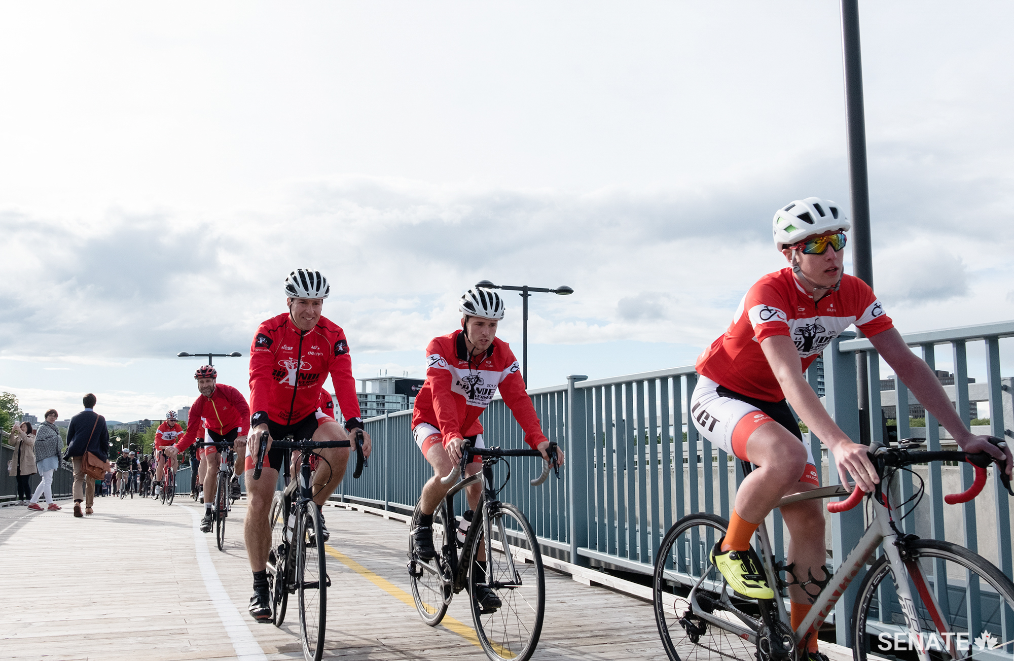 Cyclists cross back from the Quebec side of the Ottawa River via the Alexandra Bridge.
