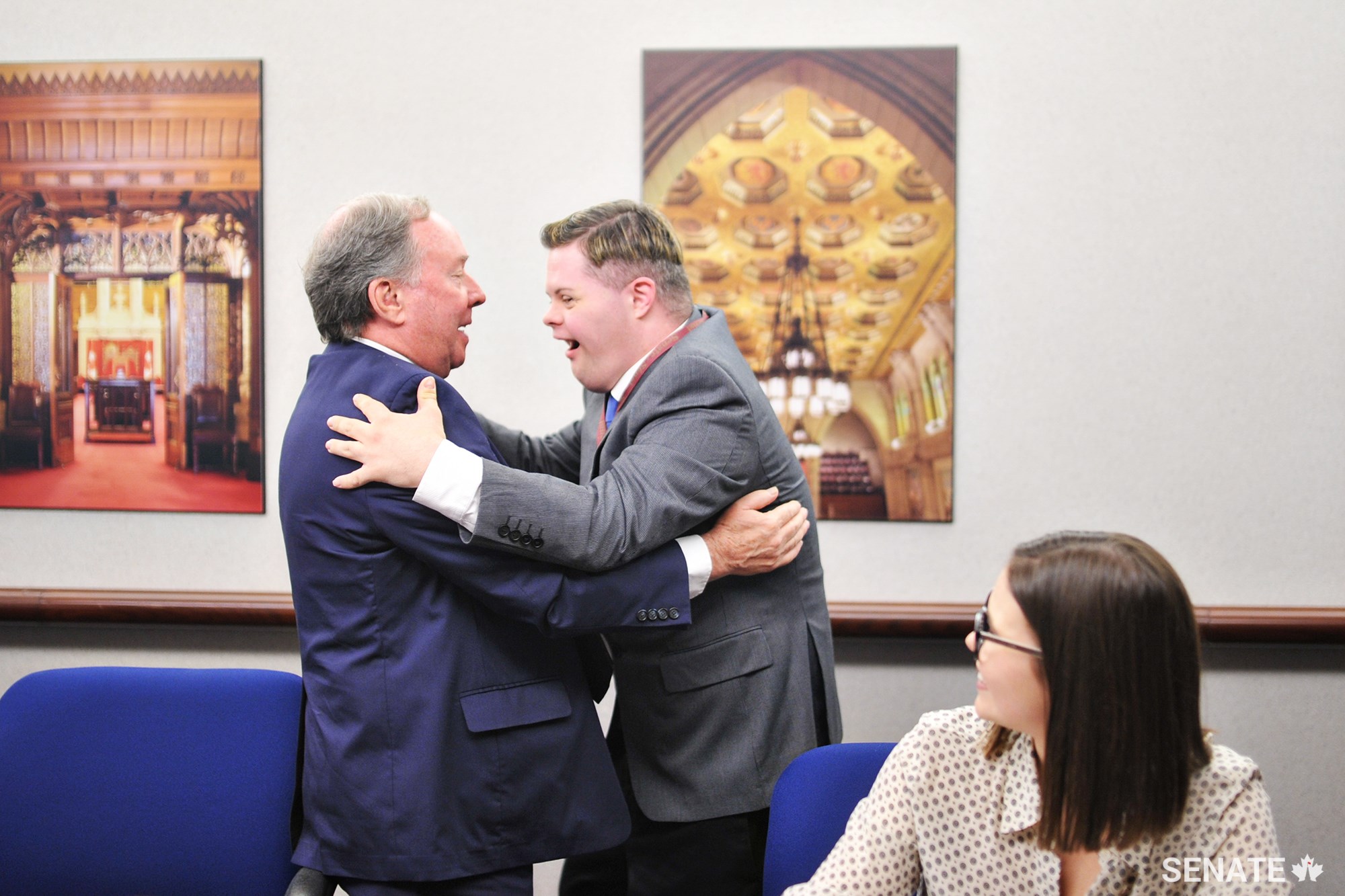 Senator Jim Munson and Michael Hurley-Trinque share a hug at the Friends of the Senate closing ceremony on June 20, 2017.