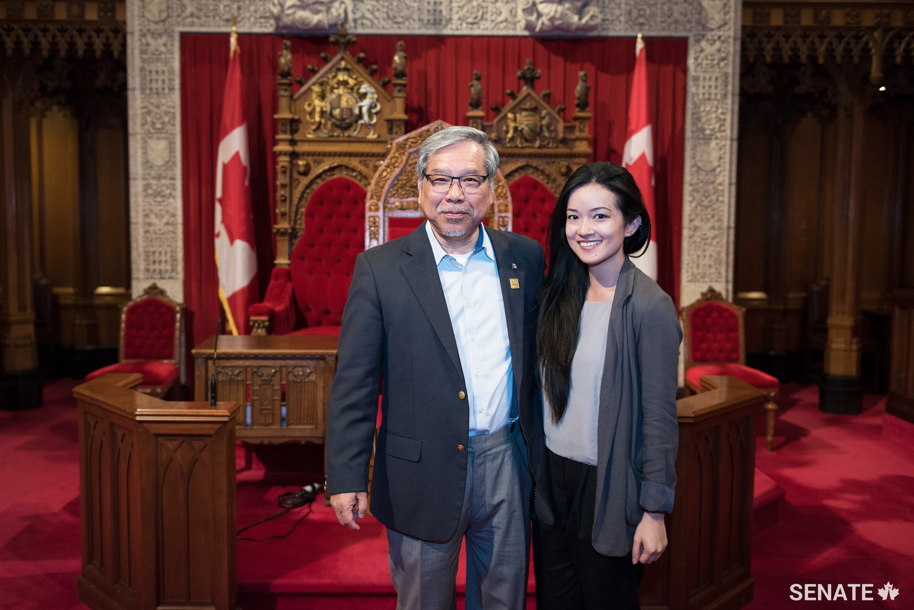 Senator Ngo and Kim Nguyen, from Vancouver, pose in the Senate Chamber.