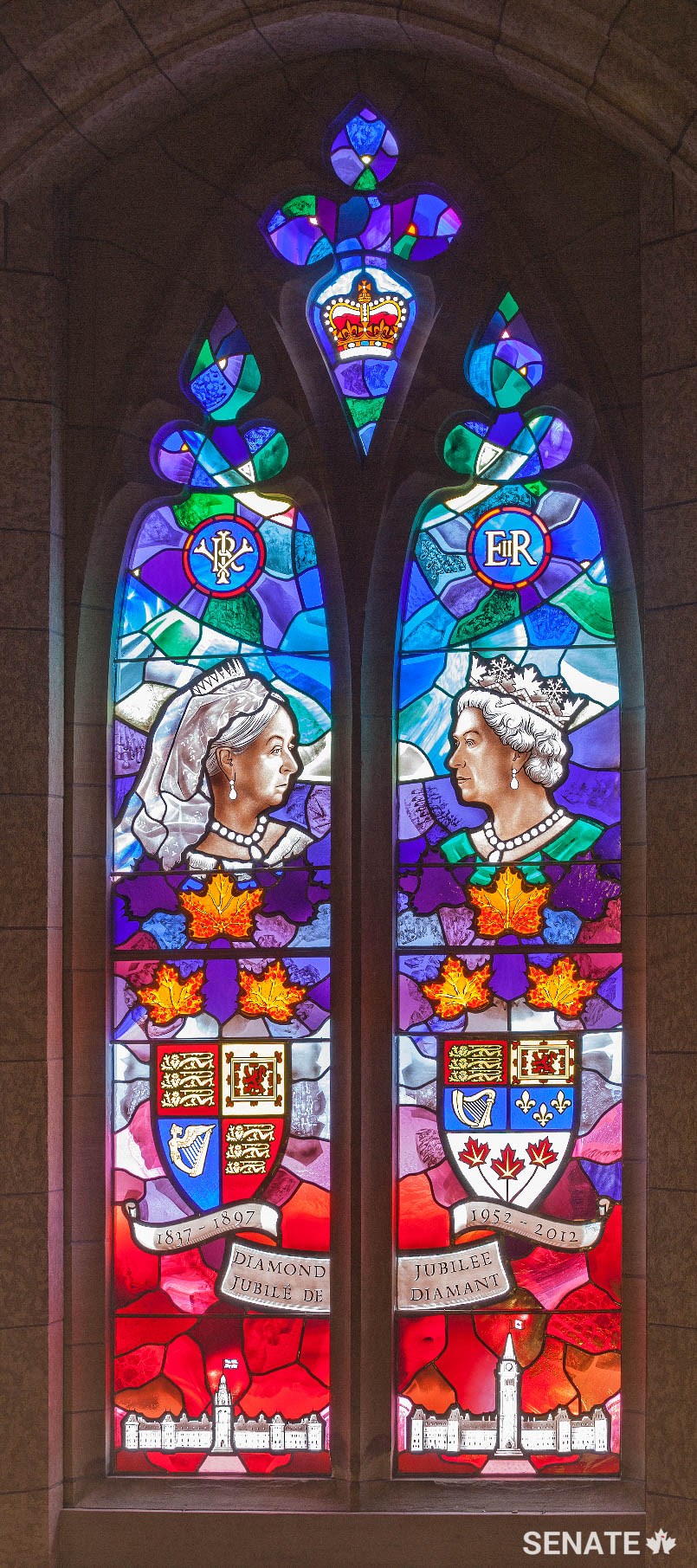 This window commemorates the Diamond Jubilee of Queen Elizabeth II in 2012, marking her 60 years on the throne. It juxtaposes her likeness with that of her great great grandmother, Queen Victoria, who celebrated her Diamond Jubilee in 1897.