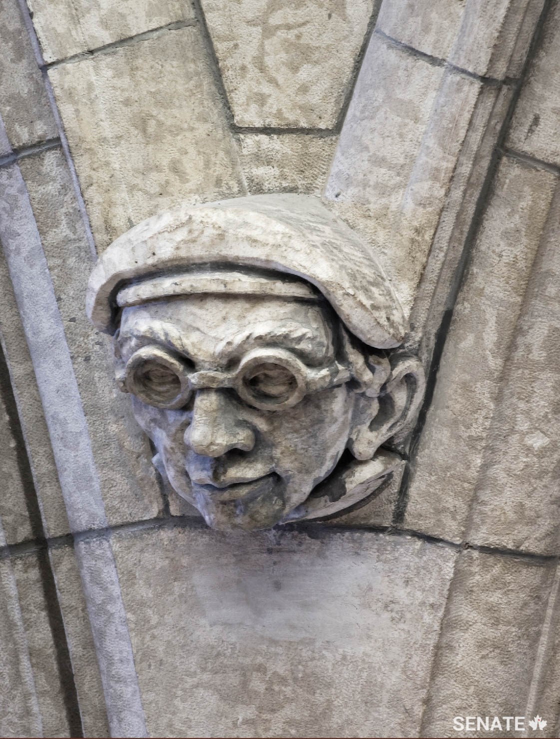 A self-portrait of one of the sculptors who worked on the Senate foyer in the 1950s stares down from high above.