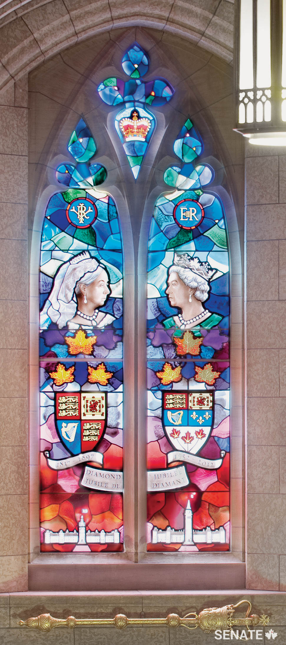 Mr. White supervised installation of the Diamond Jubilee Window above the stairway to the Senate foyer and carved the gilded Senate Mace that hangs below it.