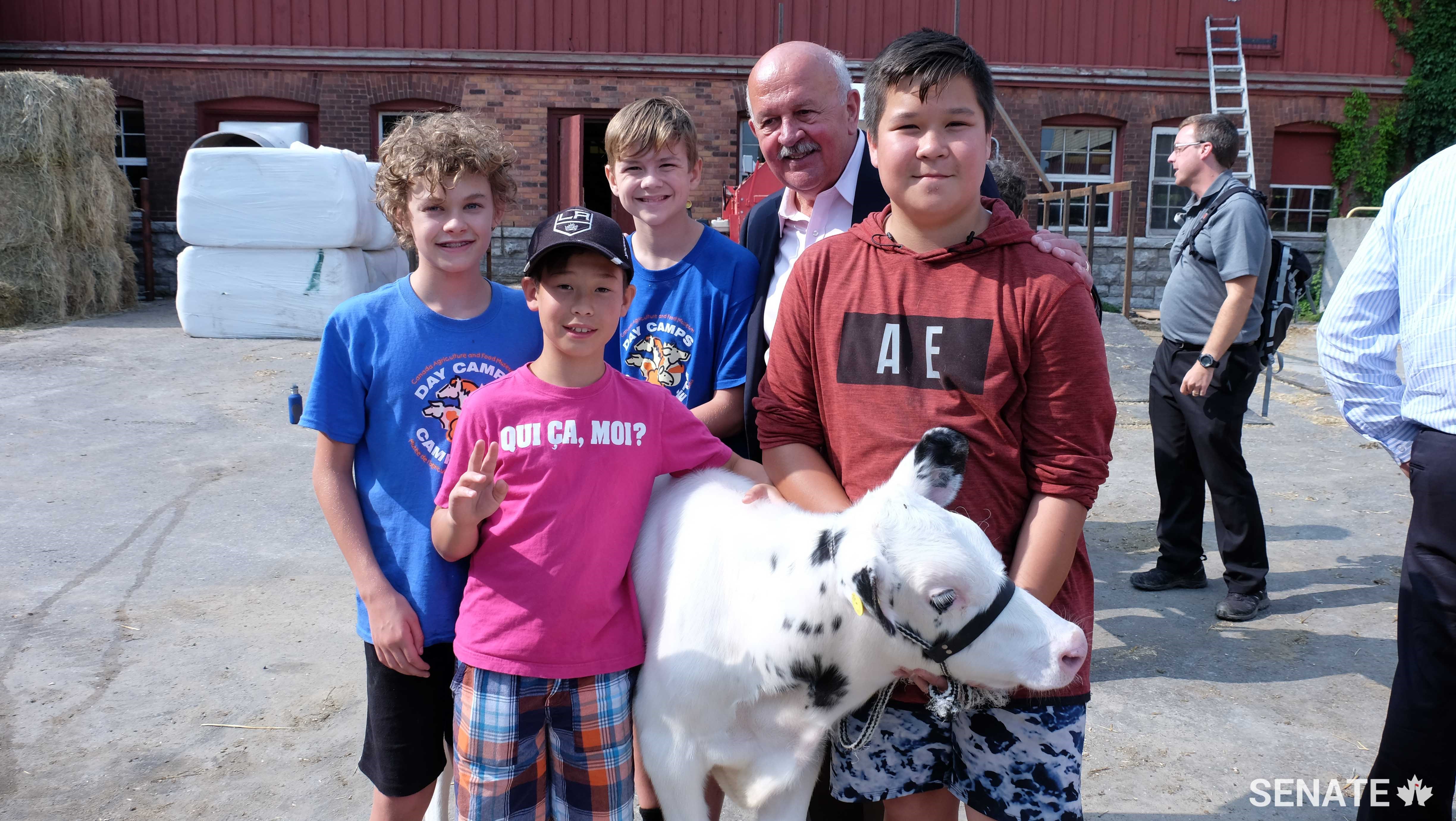 During the week of August 21-25, Tiberius the calf was in the care of campers, from left, Lawson MacDonald-Quig, Peter Gemmell, Kirk Bowby and Patrick Gemmell.