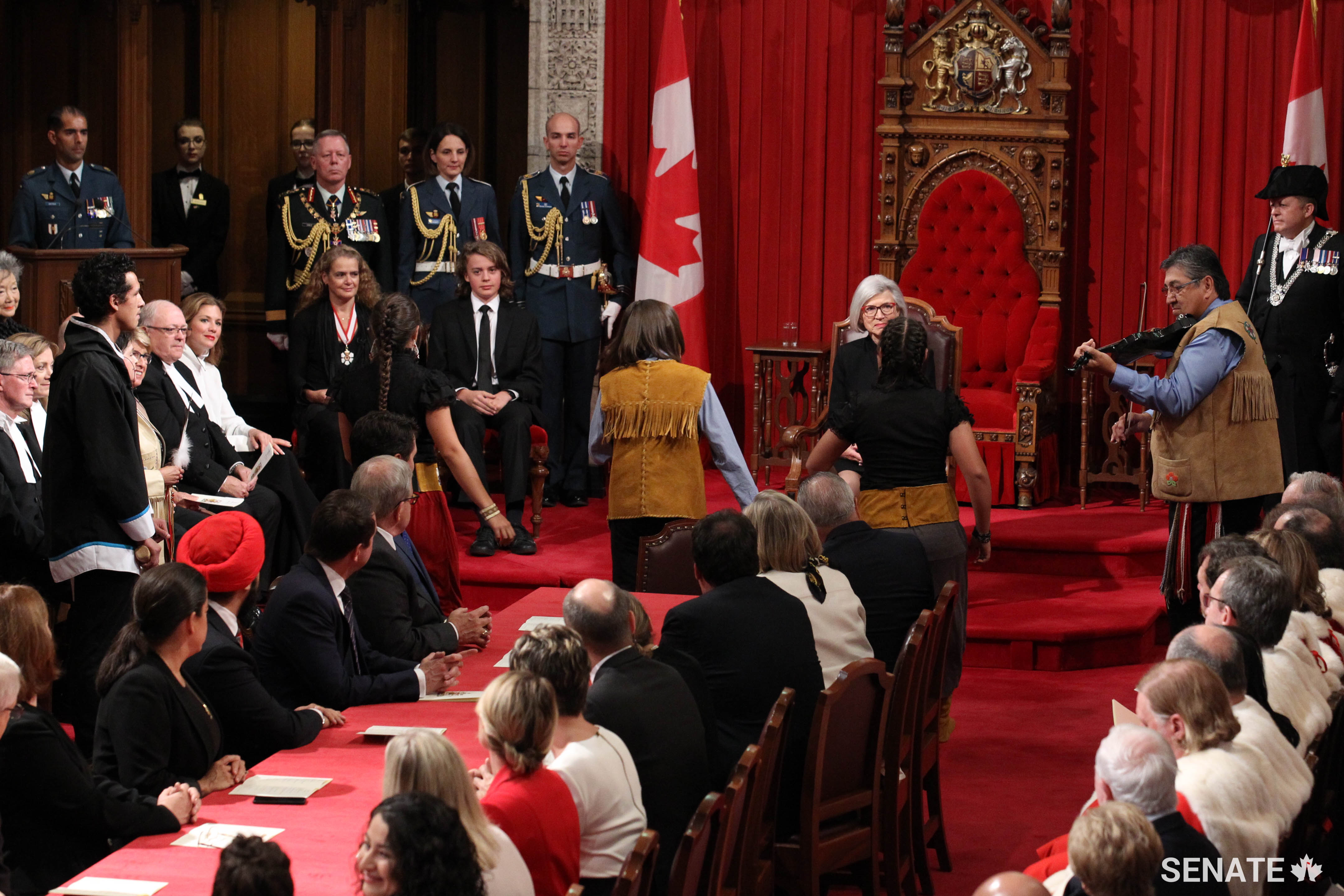 Métis fiddler Oliver Boulette (right) accompanies dance group Prairie Fire as they participate in an Indigenous welcome ceremony.