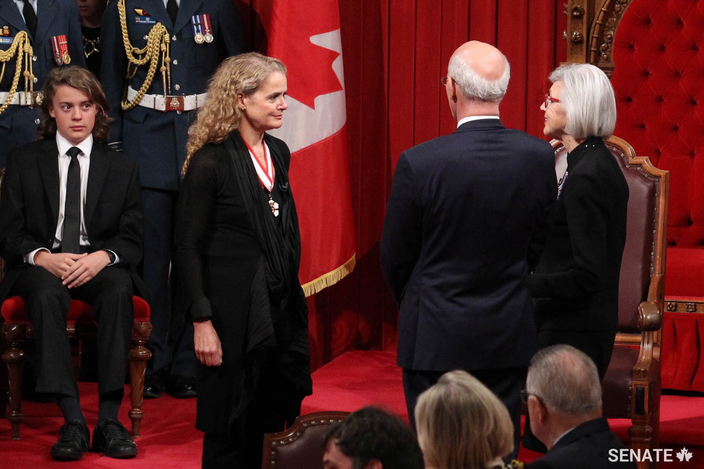 Chief Justice of Canada, Beverley McLachlin (centre) administers the formal oaths of office as Governor General Designate Julie Payette’s son, Laurier Payette Flynn, sits close by.