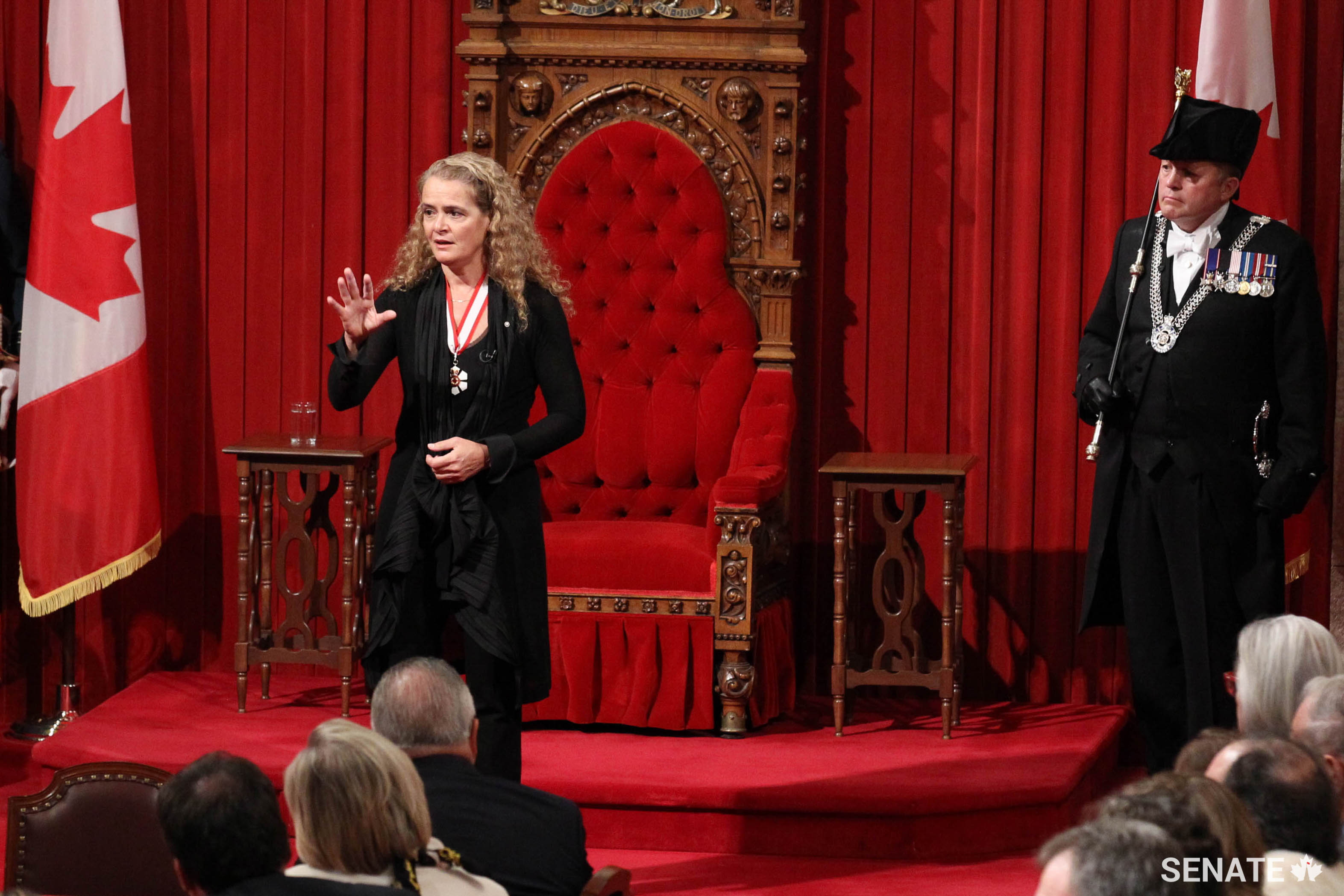 Her Excellency the Right Honourable Julie Payette delivers her first address as Governor General. Usher of the Black Rod J. Greg Peters looks on.
