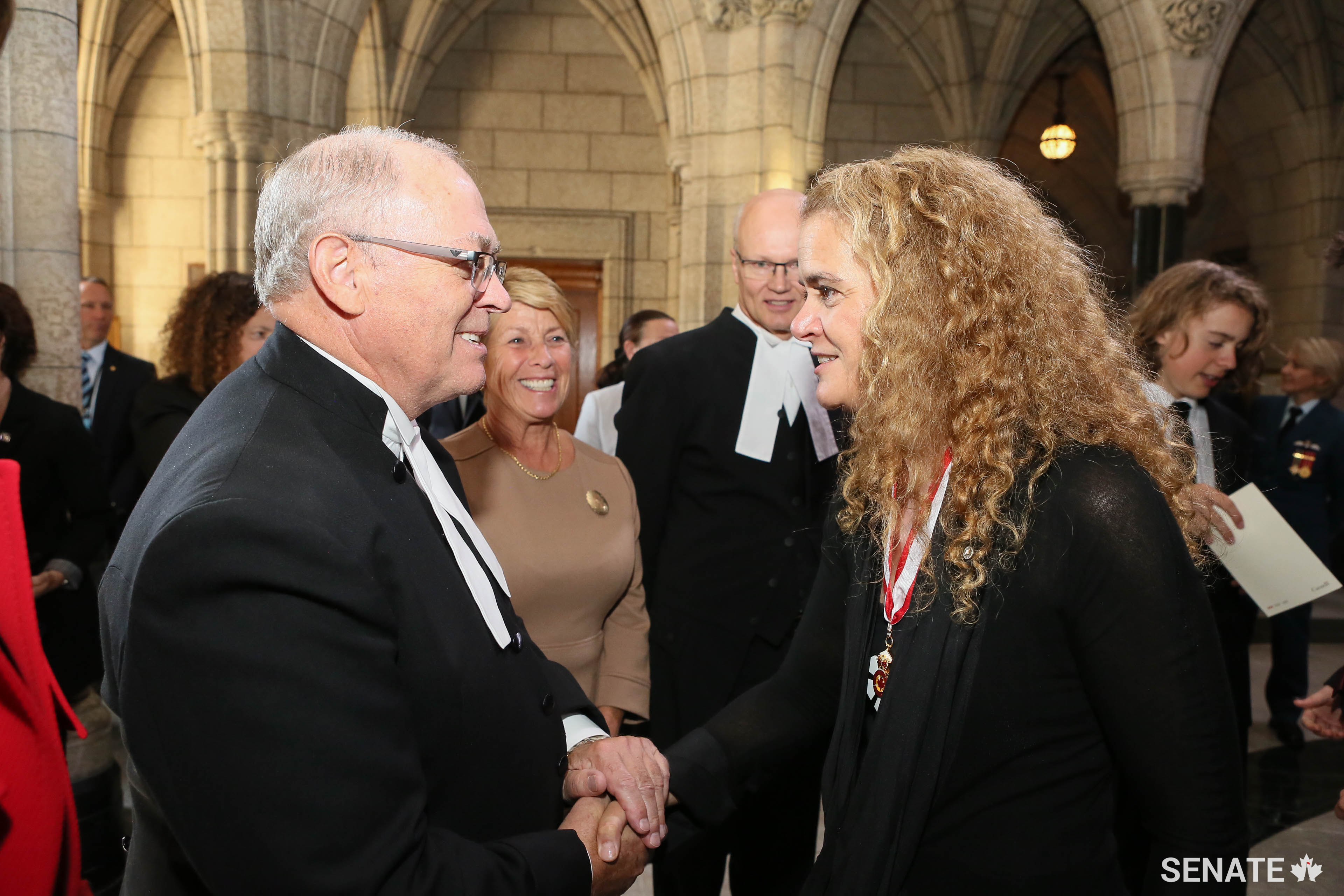Senate Speaker George J. Furey exchanges a warm handshake with Governor General Designate Julie Payette as she arrives on Parliament Hill for her swearing-in as Canada’s 29th Governor General.
