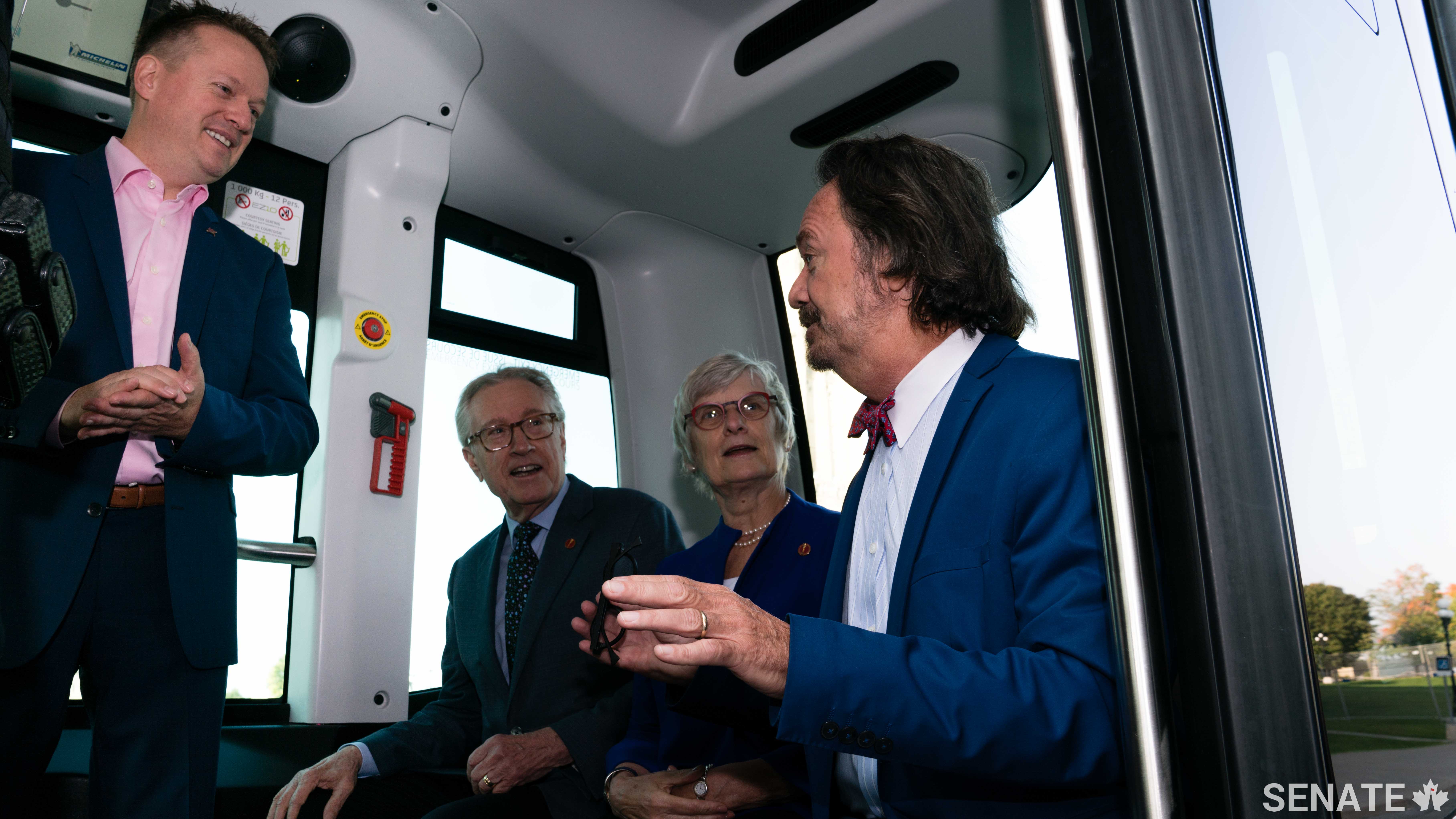 Left to right: Transdev Canada CEO Dominique Lemay talks automated technology with senators Art Eggleton, Patricia Bovey and Dennis Dawson.