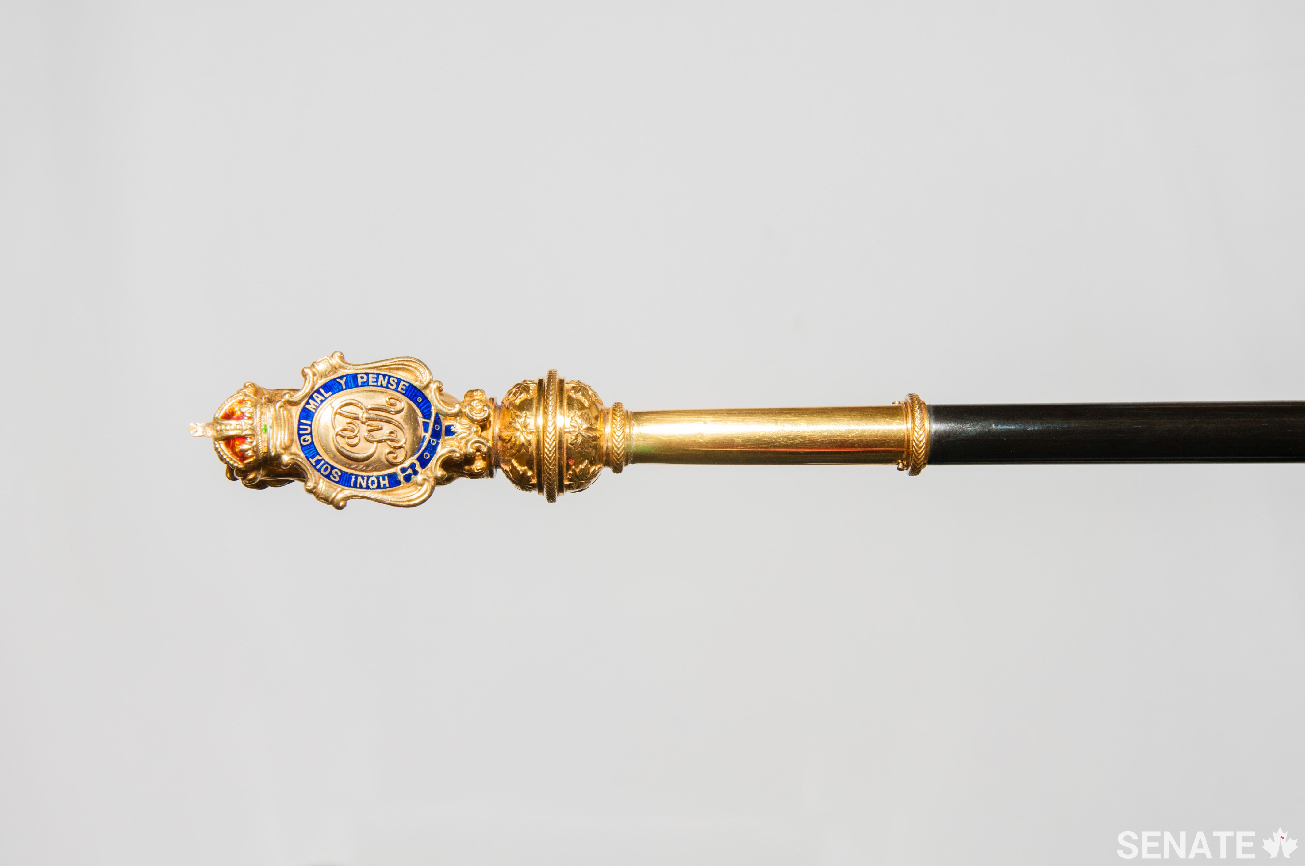 While the British Black Rod is decorated with the cypher of Edward VII, the Canadian Black Rod is decorated with the cypher of George V, who was king at the time of its design in 1916.