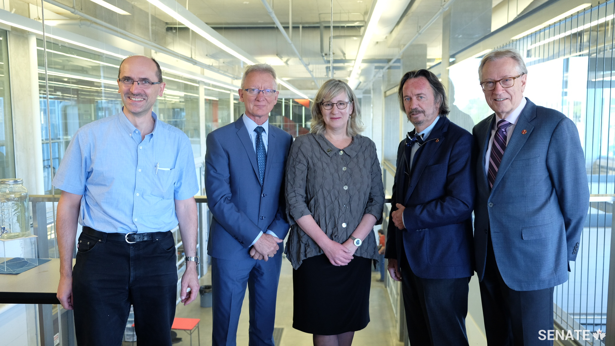 Senators meet with University of Waterloo vice-president Sandra Banks, centre, and Engineering professor Krzysztof Czarnecki, left, inside the Sedra Student Design Centre at the University of Waterloo on October 3, 2017.