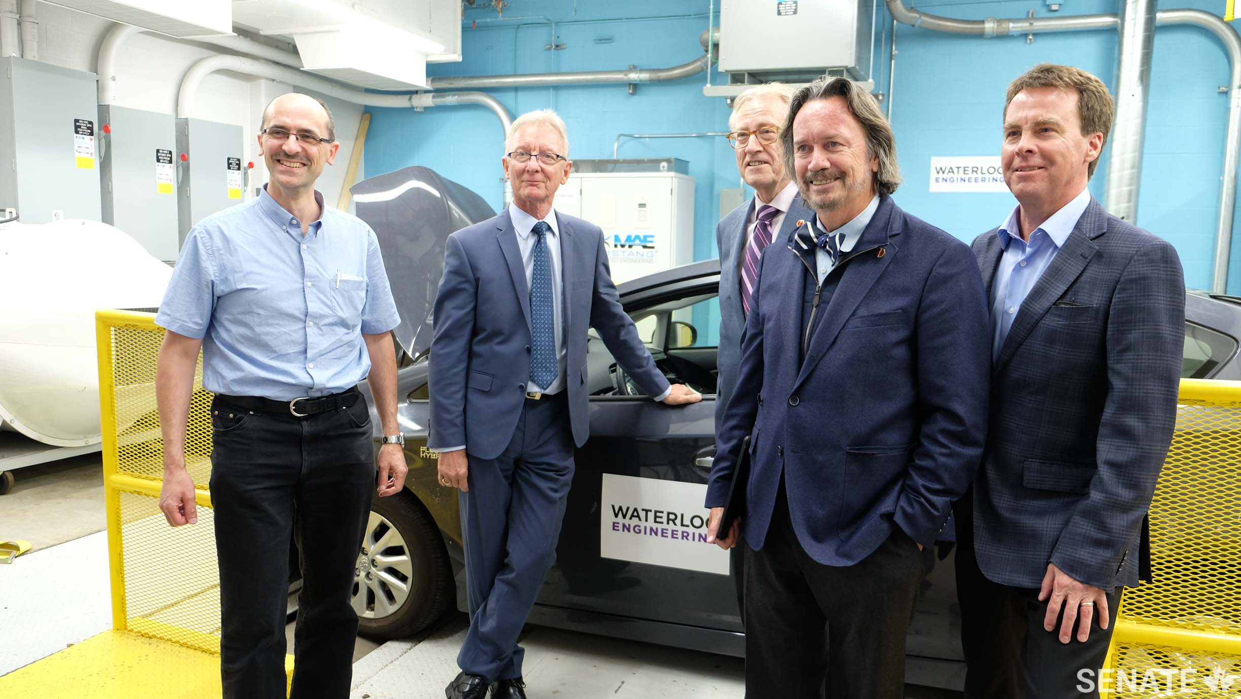 Professor Kryzysztof Czarnecki, left, and Professor John McPhee, right, from the University of Waterloo Engineering department brief senators Pierre-Hugues Boisvenu, Art Eggleton and Dennis Dawson in the lab at WatCar during the Senate Committee on Transport and Communication’s fact-finding mission to Waterloo on October 3, 2017.