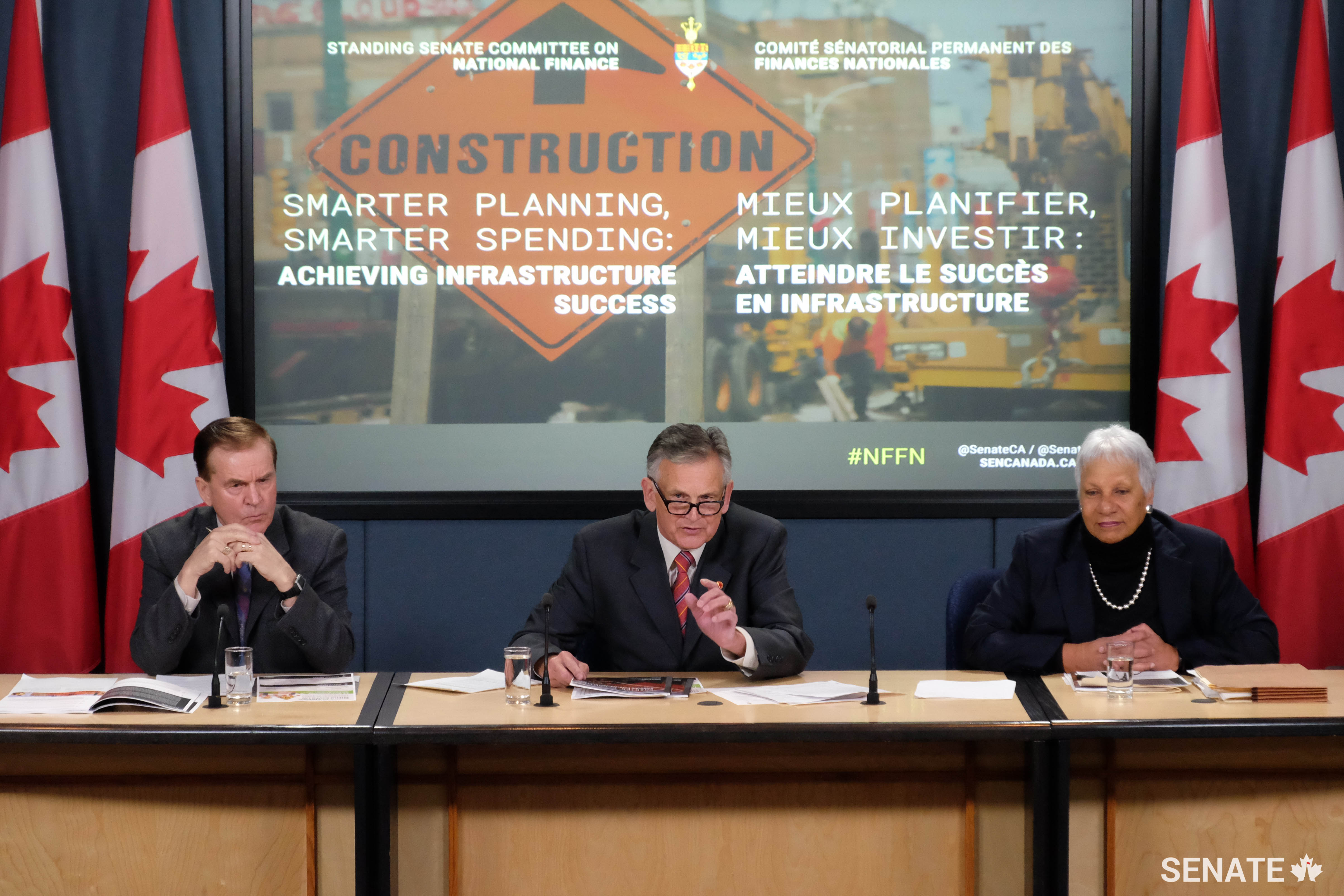Senator Smith, flanked by senators Percy Mockler and Anne C. Cools, answers questions from journalists at the report launch for the Senate Committee on National Finance’s study on the federal government’s infrastructure program in Ottawa in February 2017.