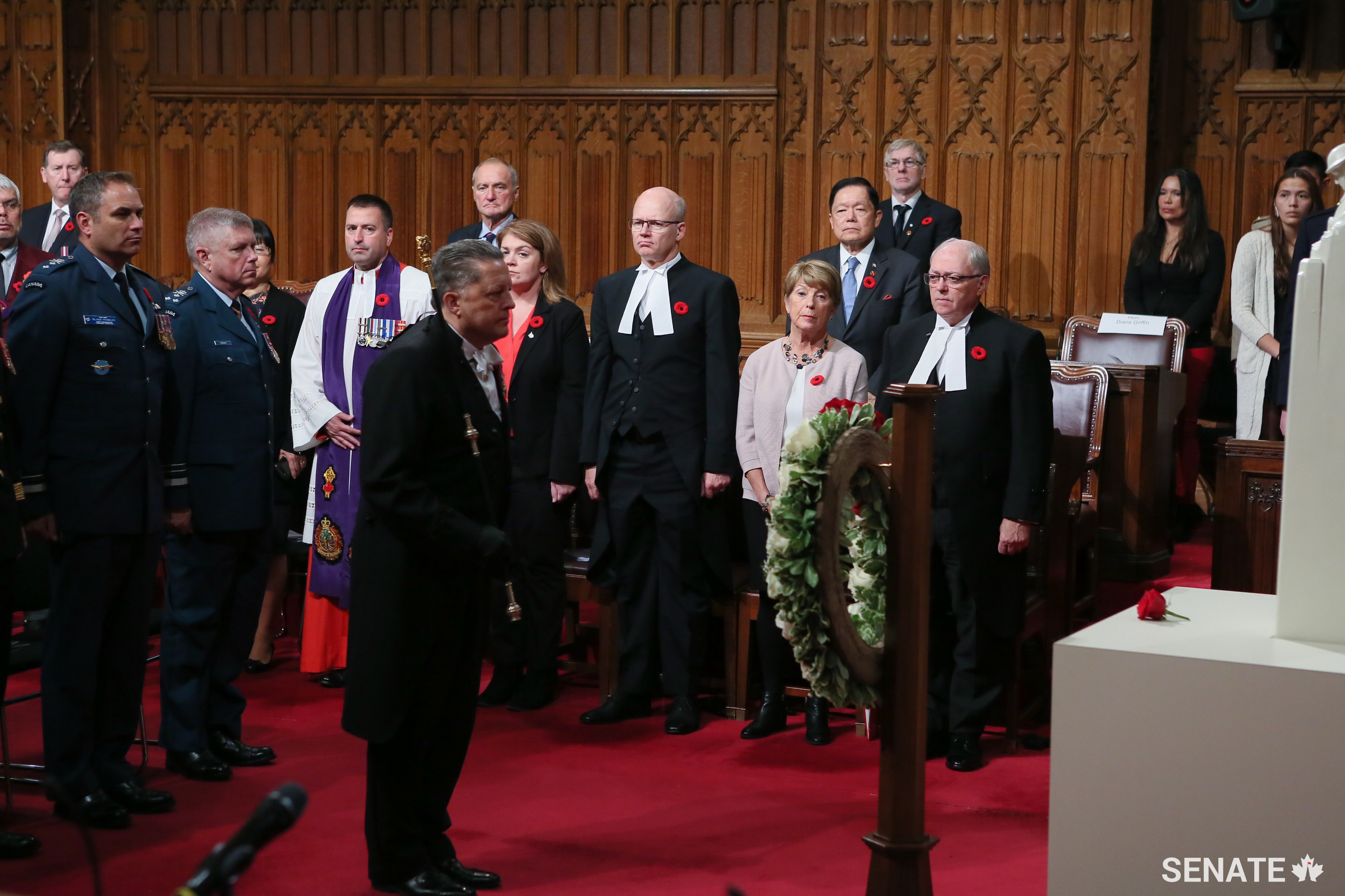 After a moment of silence, Usher of the Black Rod J. Greg Peters prepares to lead the procession out of the Chamber.