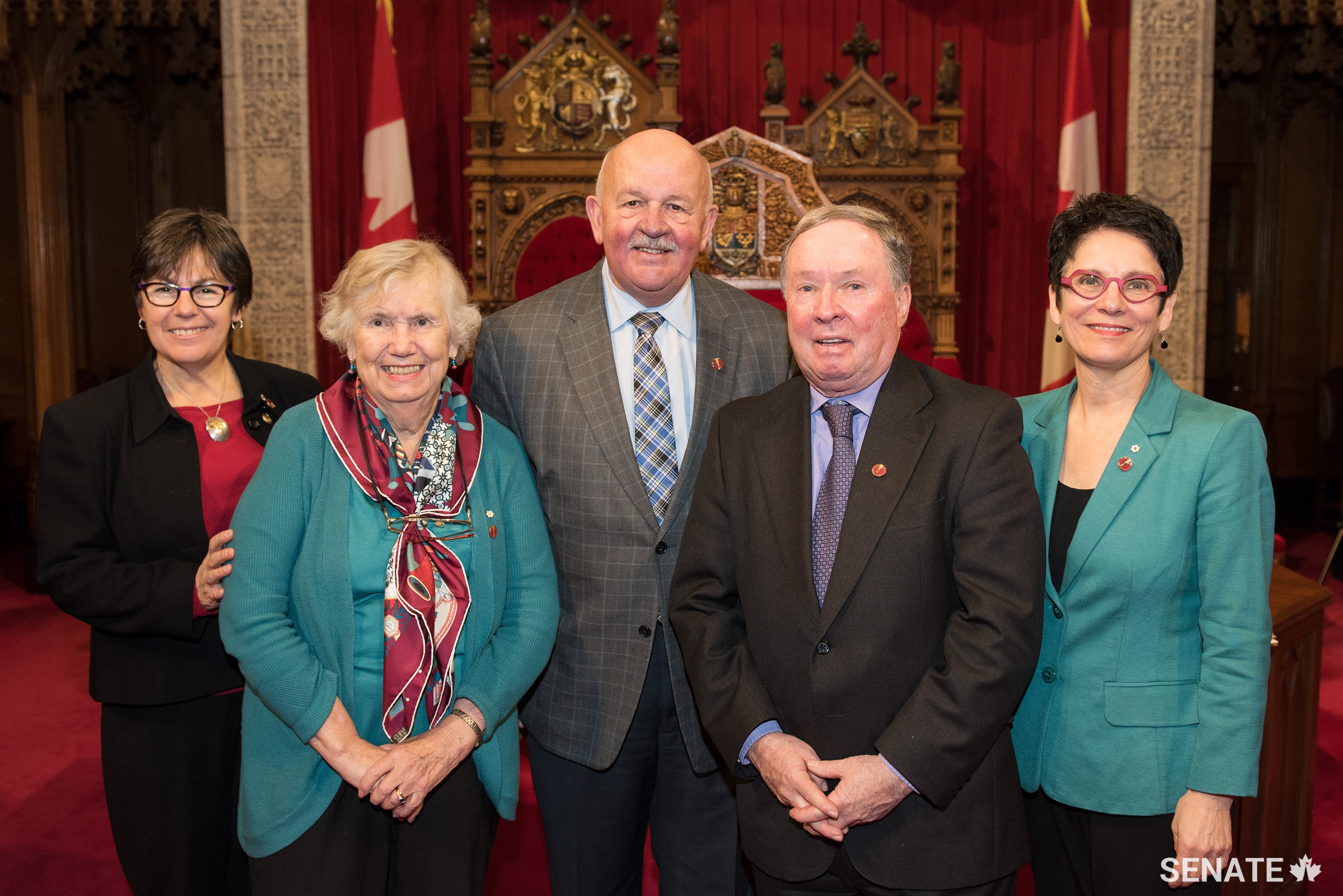 From left, Senator Kim Pate, former senator Landon Pearson and senators Terry Mercer, Jim Munson and Raymonde Gagné celebrate National Child Day in the Red Chamber.