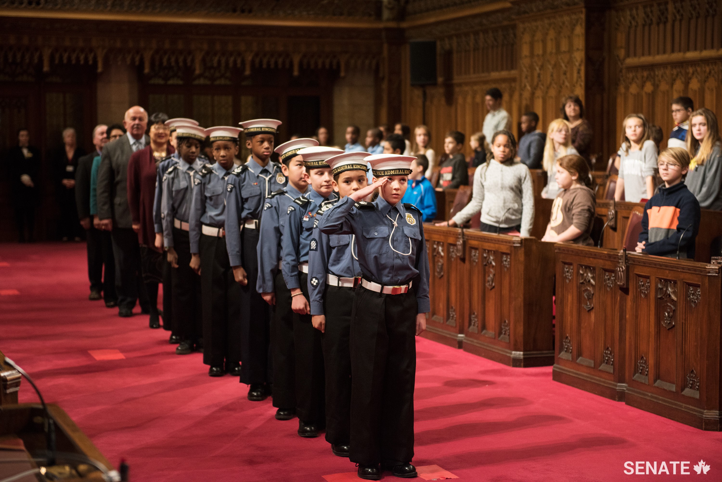 Cadets from the Navy League of Canada usher senators into the Red Chamber to kick off National Child Day celebrations.