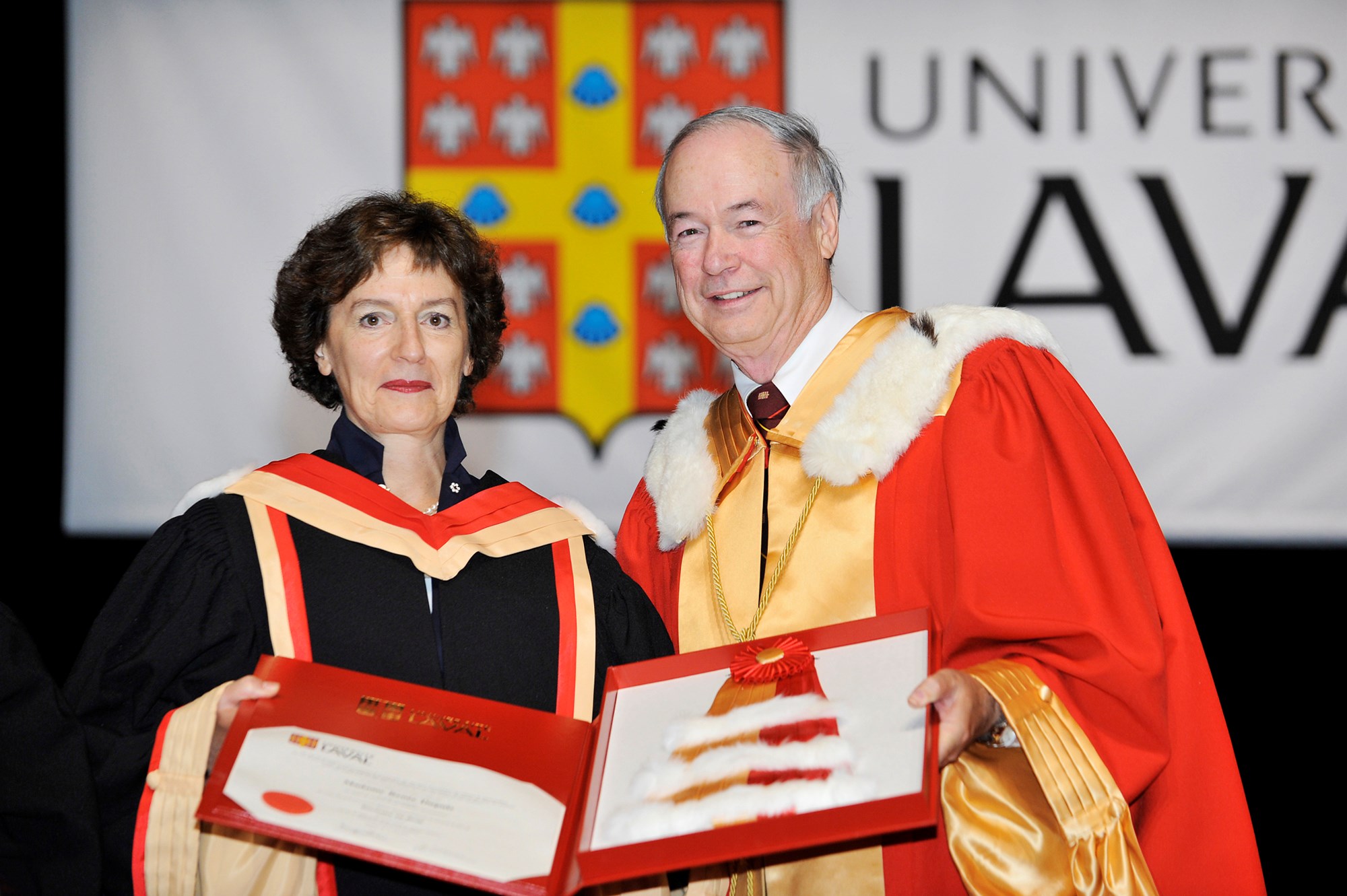 Rector Denis Brière presents Senator Dupuis with an honorary Doctor of Laws degree from the University of Laval in June 2012.