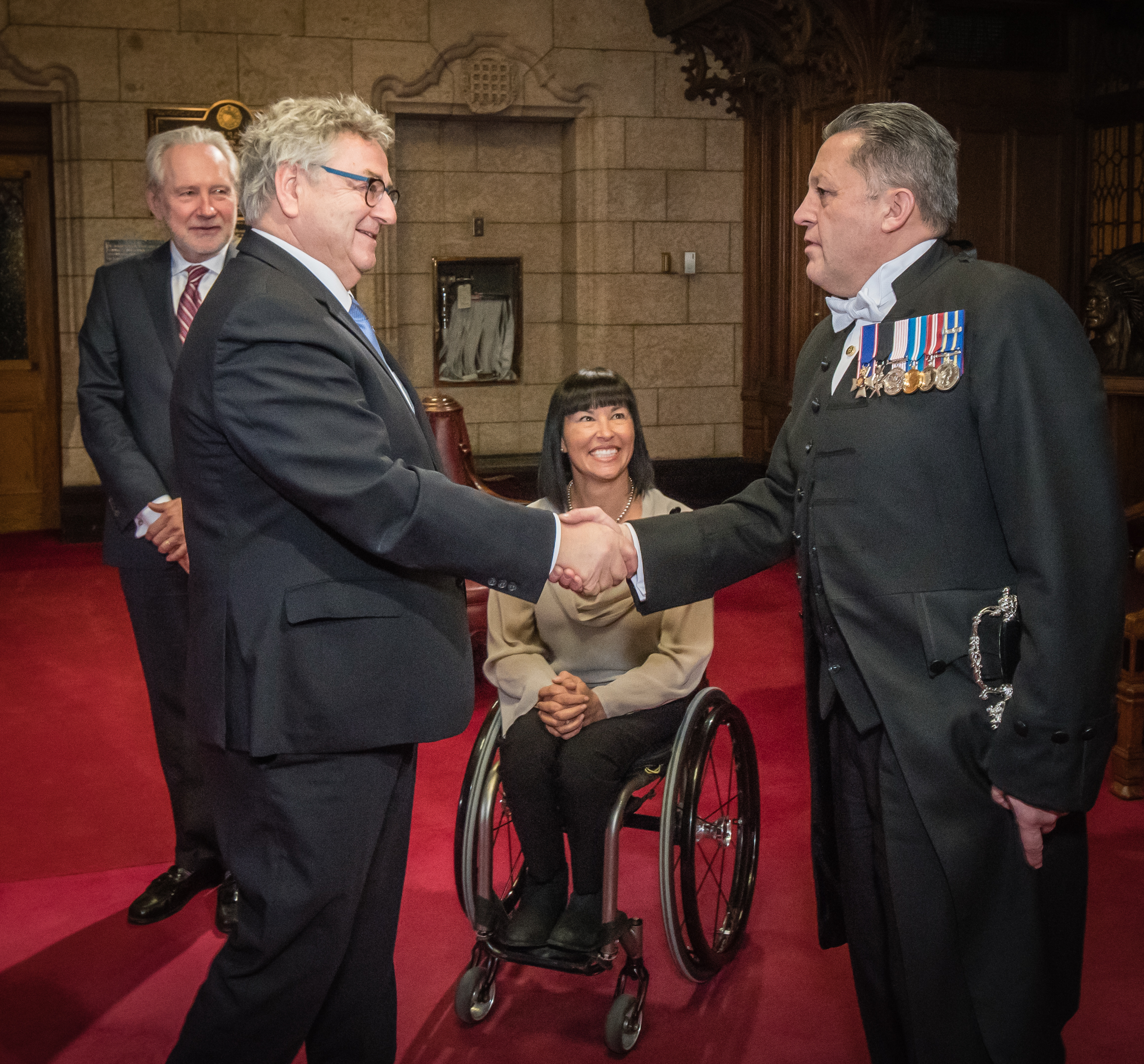 Senator Forest is sworn in as a senator in November 2016, joined here by Senator Chantal Petitclerc, the Usher of the Black Rod Greg J. Peters and Senator Peter Harder.