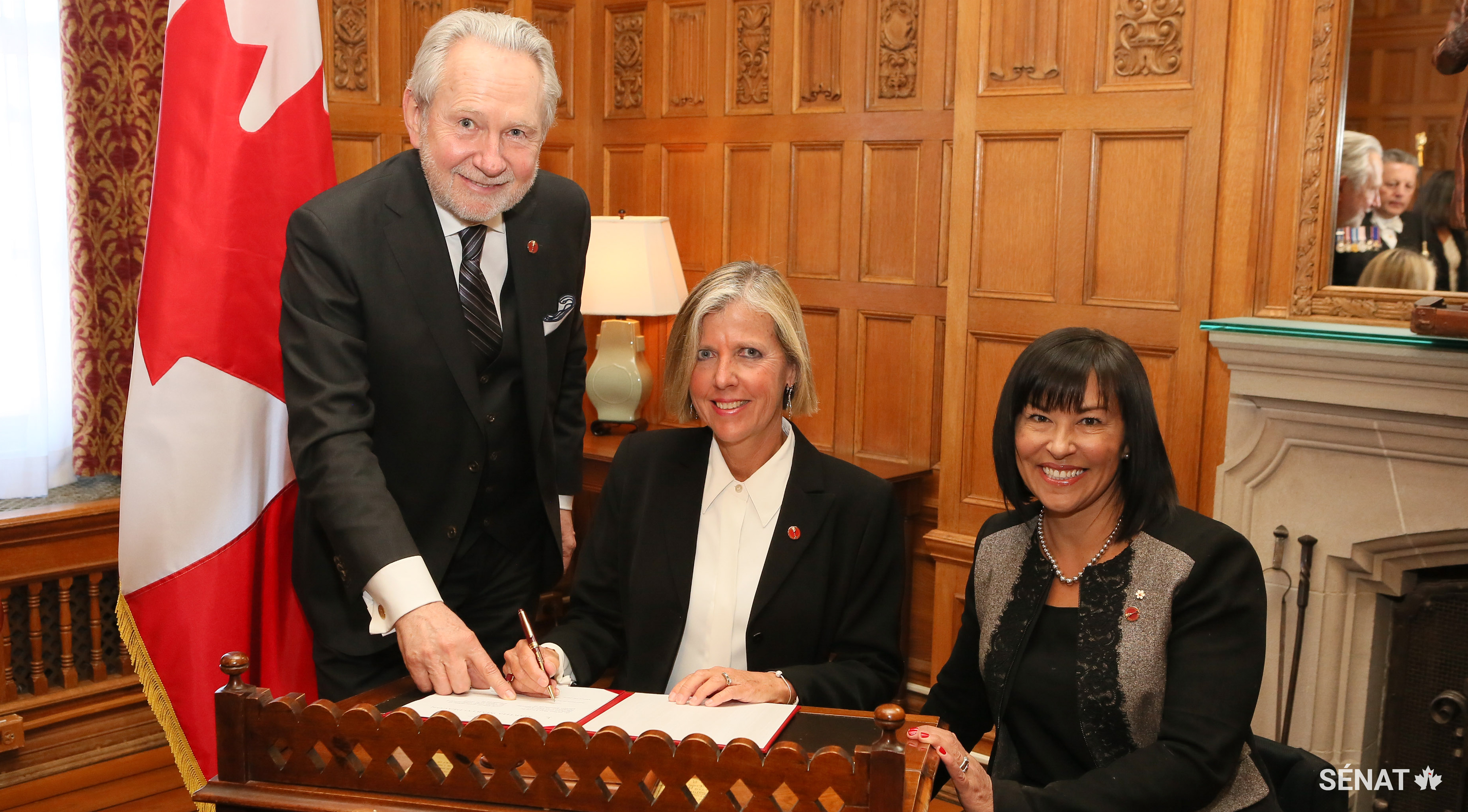 La sénatrice Marty Deacon (centre) se joint à la Chambre haute, entourée du sénateur Peter Harder (gauche) et de la sénatrice Chantal Petitclerc (droite).