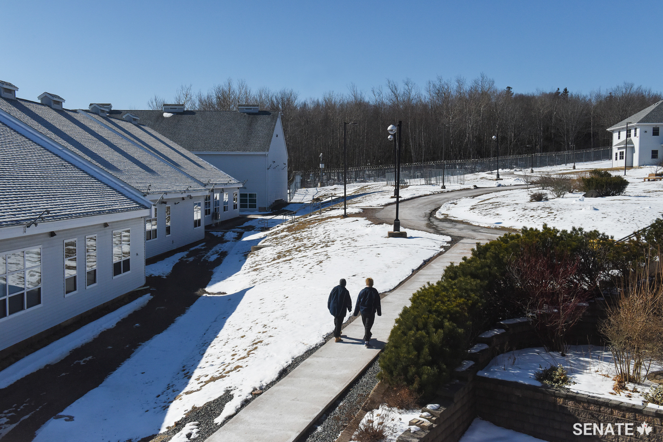 A pair of prisoners walk through the snow-covered grounds of the Nova Institution for Women.