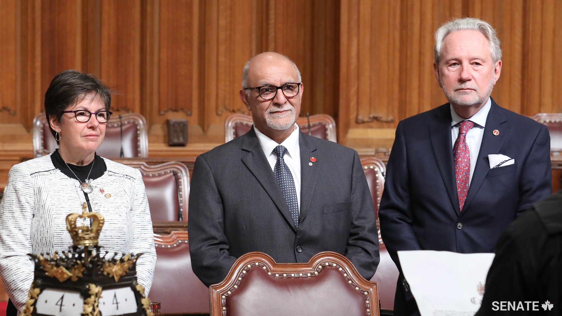 Senator Mohamed-Iqbal Ravalia, centre, is sworn in as senators Kim Pate and Peter Harder look on.