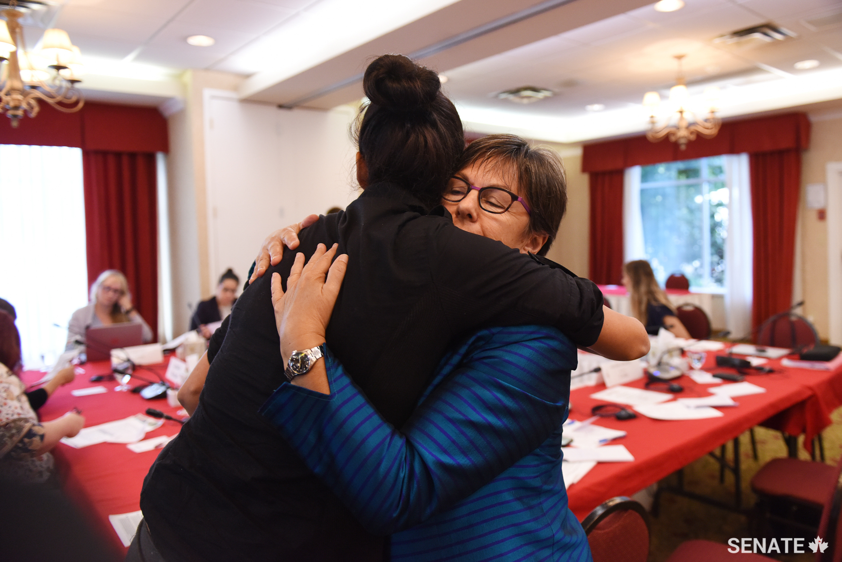 Senator Pate hugs a witness who testified before the committee during a public hearing.