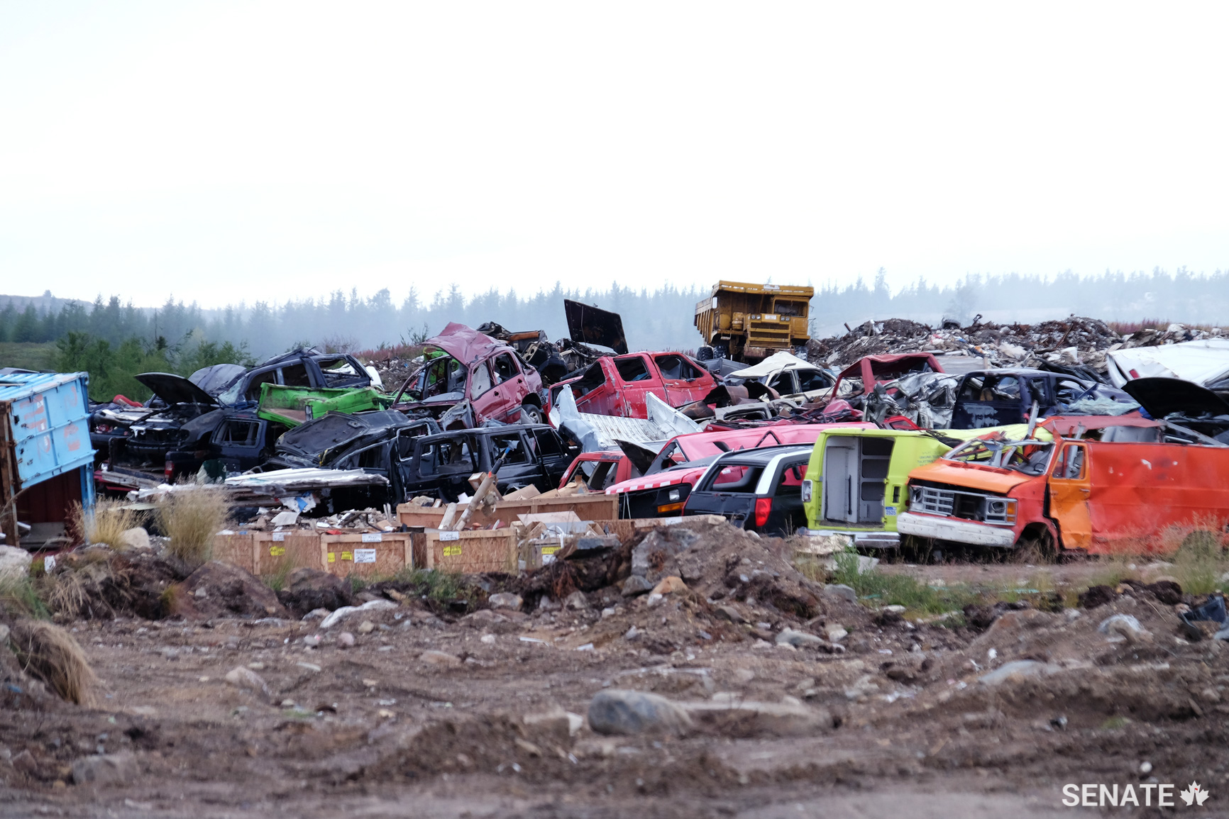 Crumpled vehicles lie in a Kuujjuaq landfill. The landfill was the first in Nunavik to receive federal government funding to sort waste. But the cost of shipping metal to recycle is so high that it sits in the landfill with the garbage. The community wants to see more government funding to be able to burn the waste and turn it into energy for local buildings.